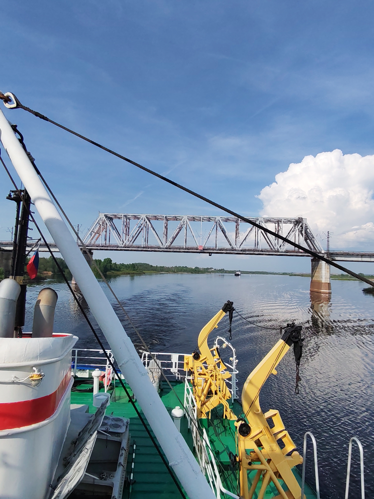 River traffic passes under railway bridge in Russia
