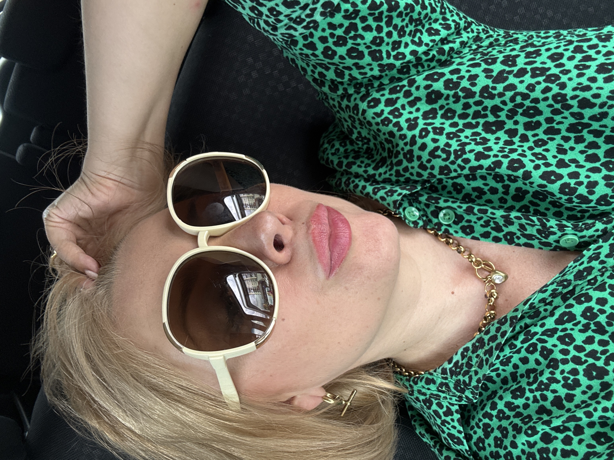 Car selfie session in Sochi, green leopard print and sunglasses.