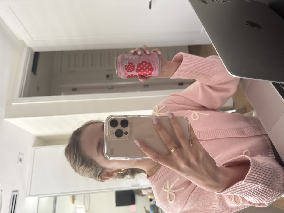 Woman takes mirror selfie with smartphone in Coral Gables