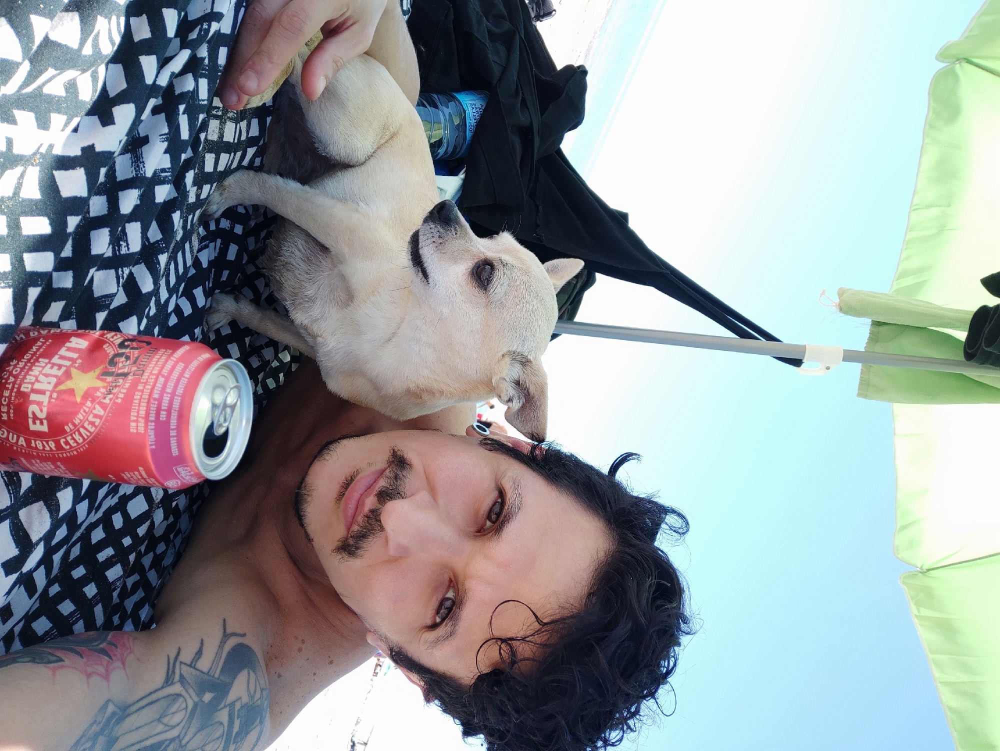 Man and dog enjoy sunny day at Castelldefels beach