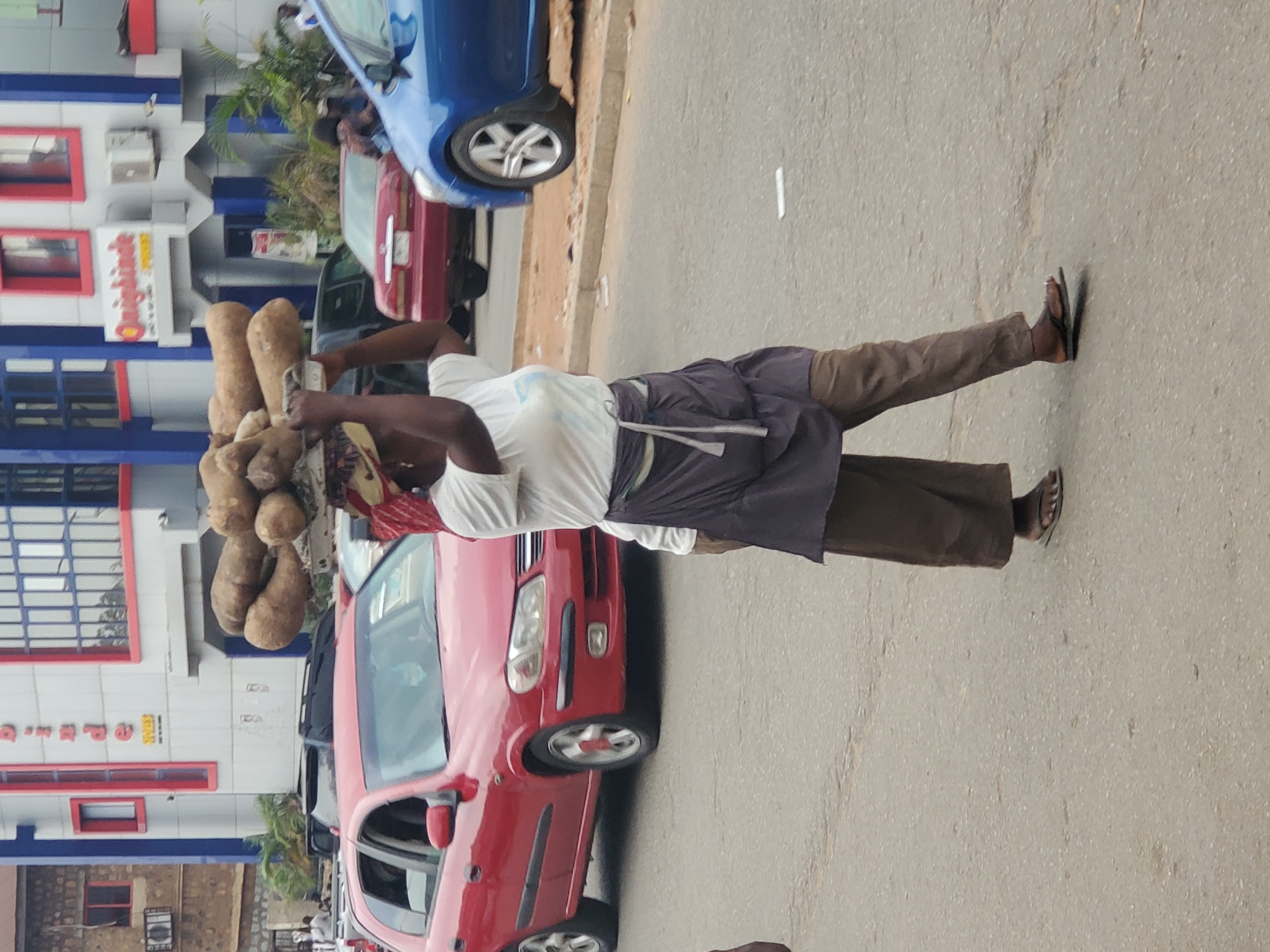 Street vendors conduct business at Jos market