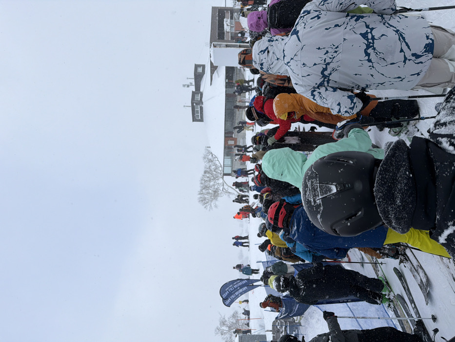 Skiers gather in line during snowy day in Kutchan