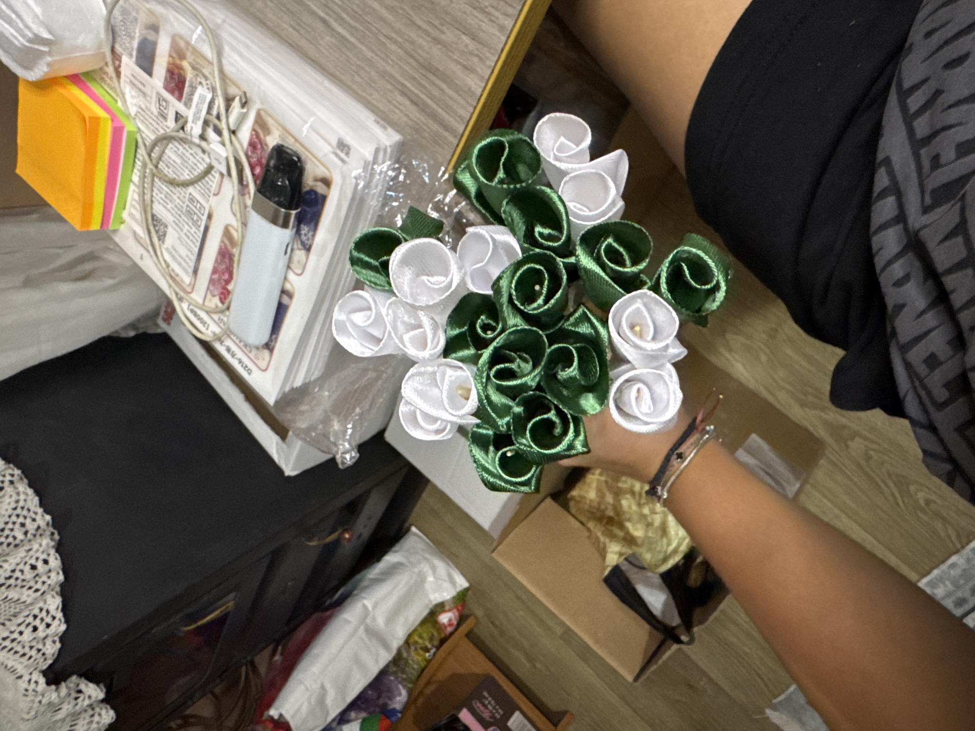 Handmaking satin ribbon roses in a Bulgarian craft workshop