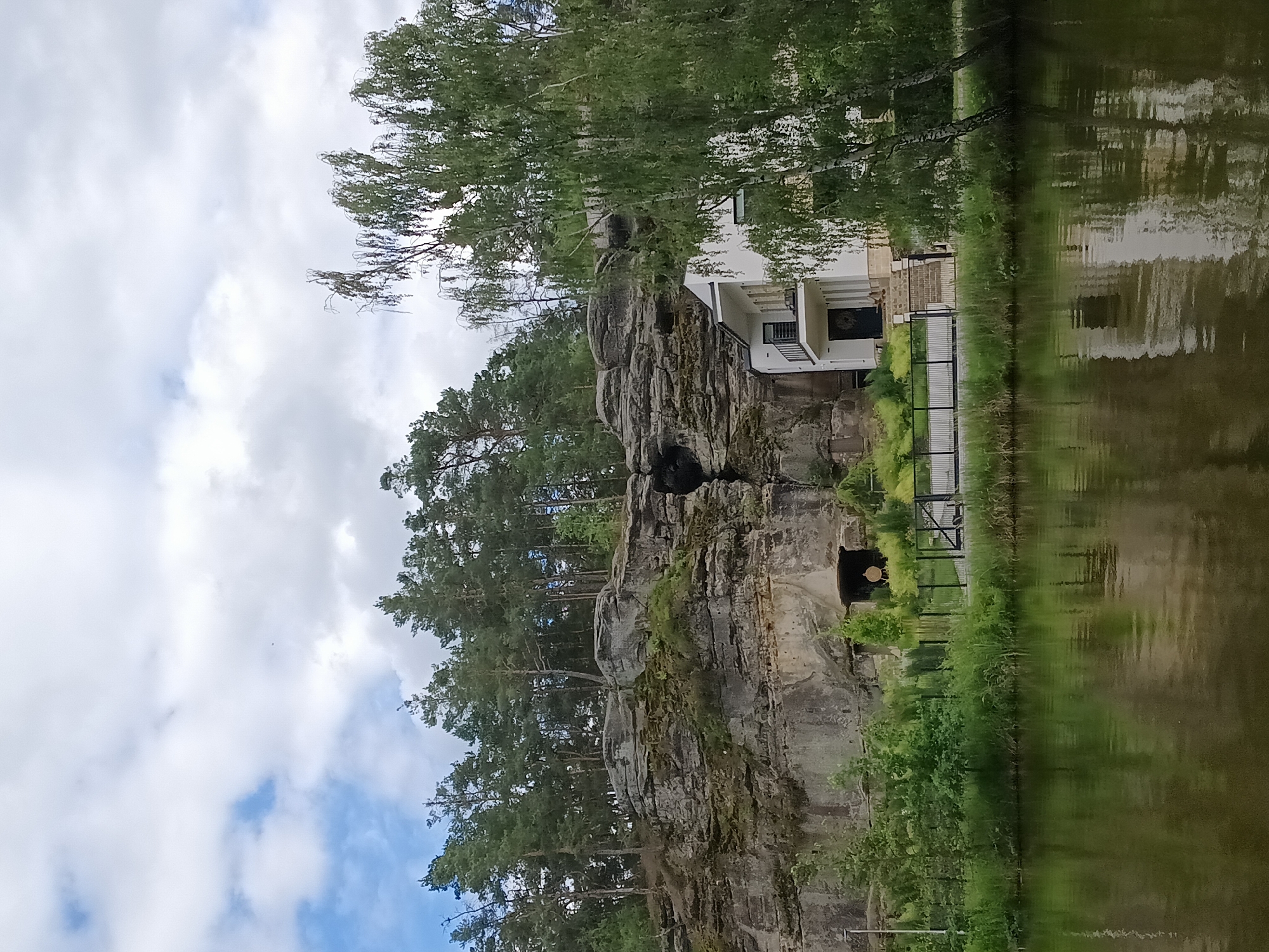 Sandstone cliffs, forest lake, and overcast skies in Nová Ves