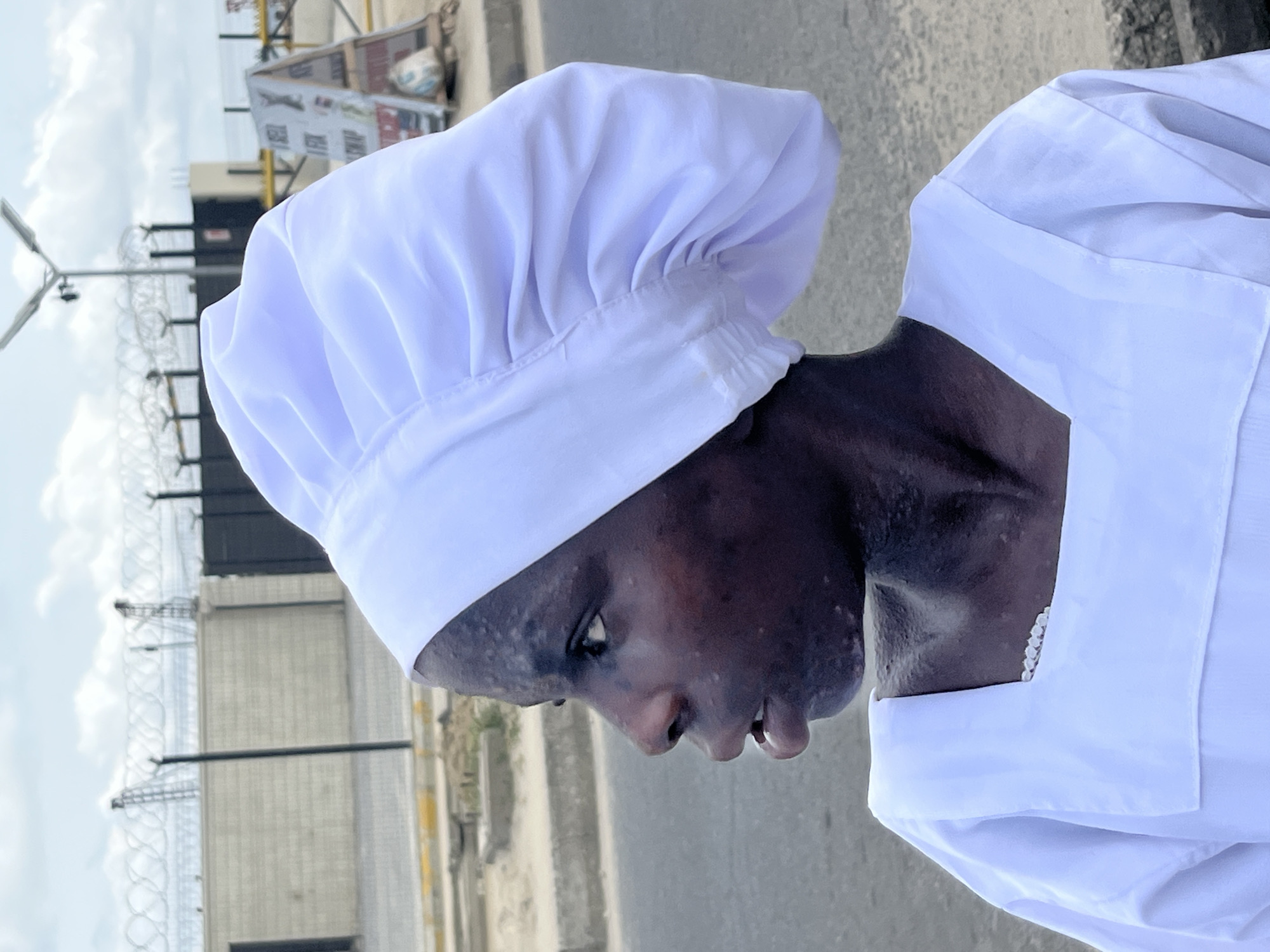 Chefs in white uniforms gathered on Ado street