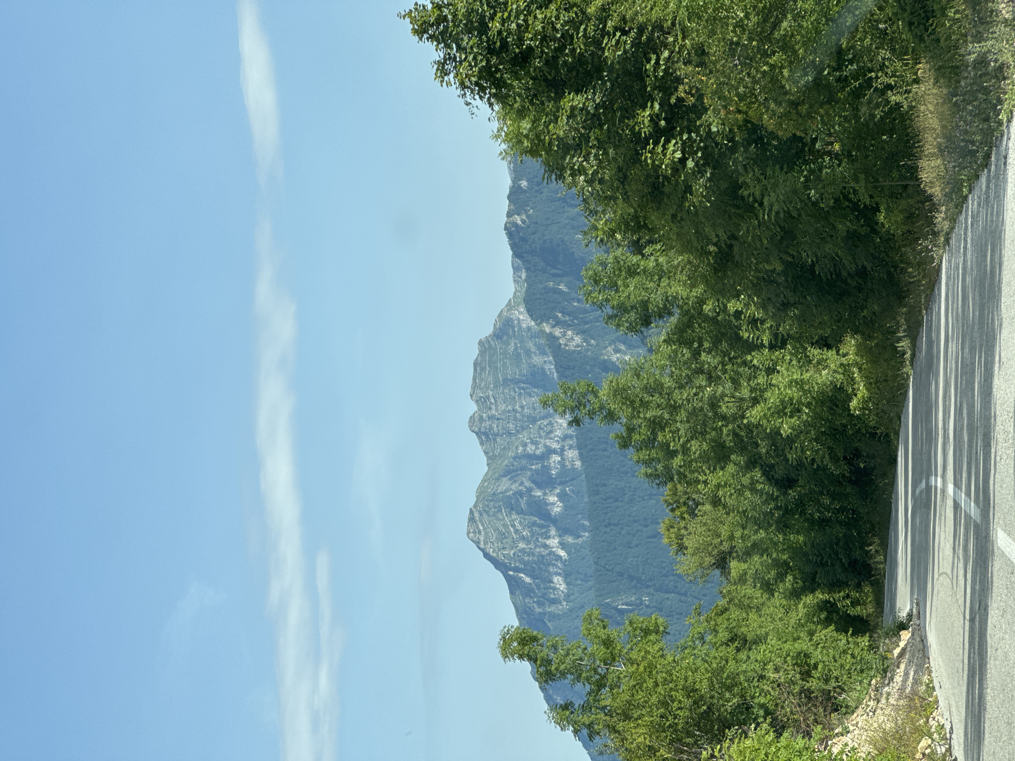 Mountain road and peaks under clear skies in rural Montenegro