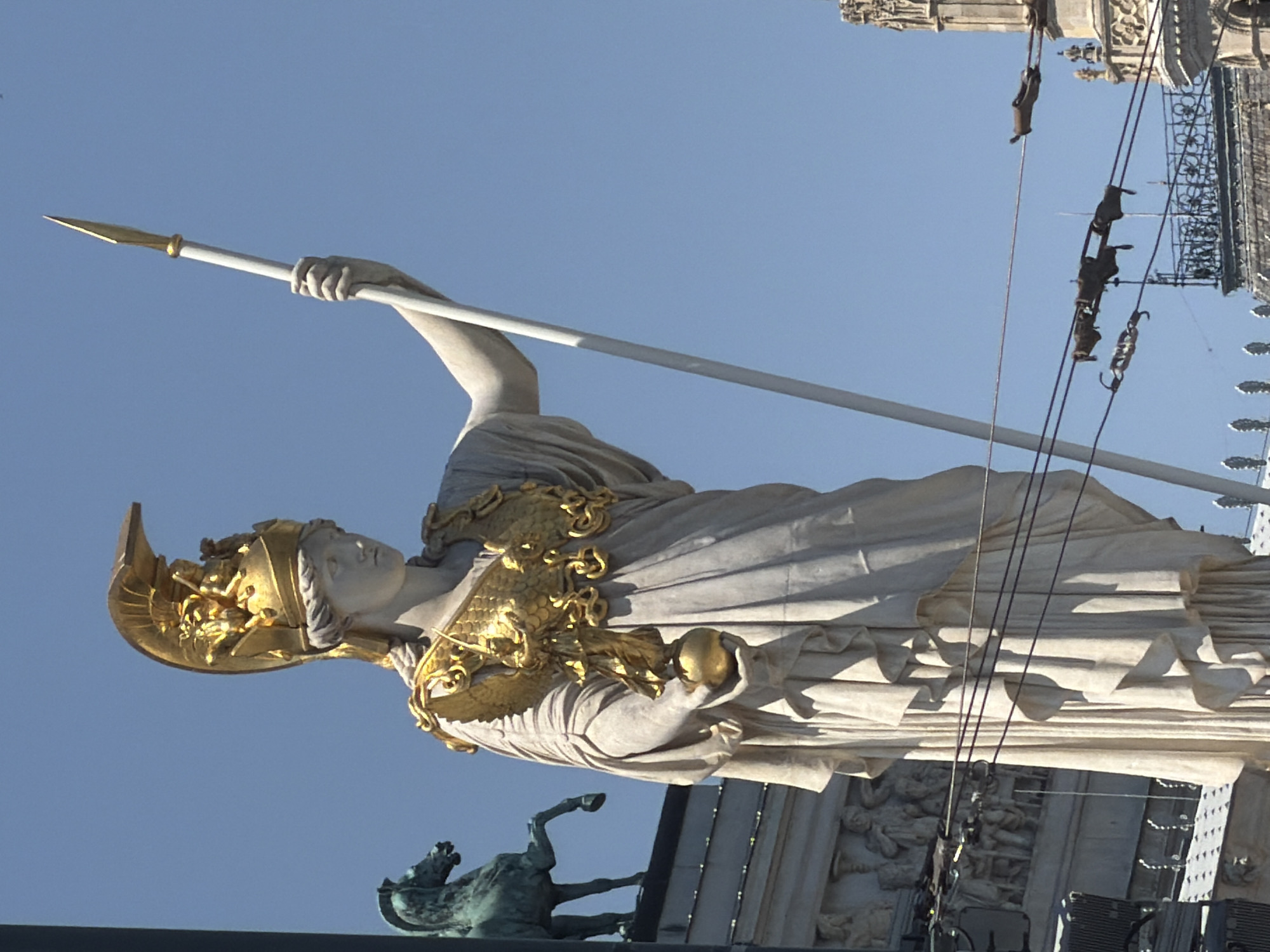 Vienna's Parliament and its classical statuary on a sunny morning