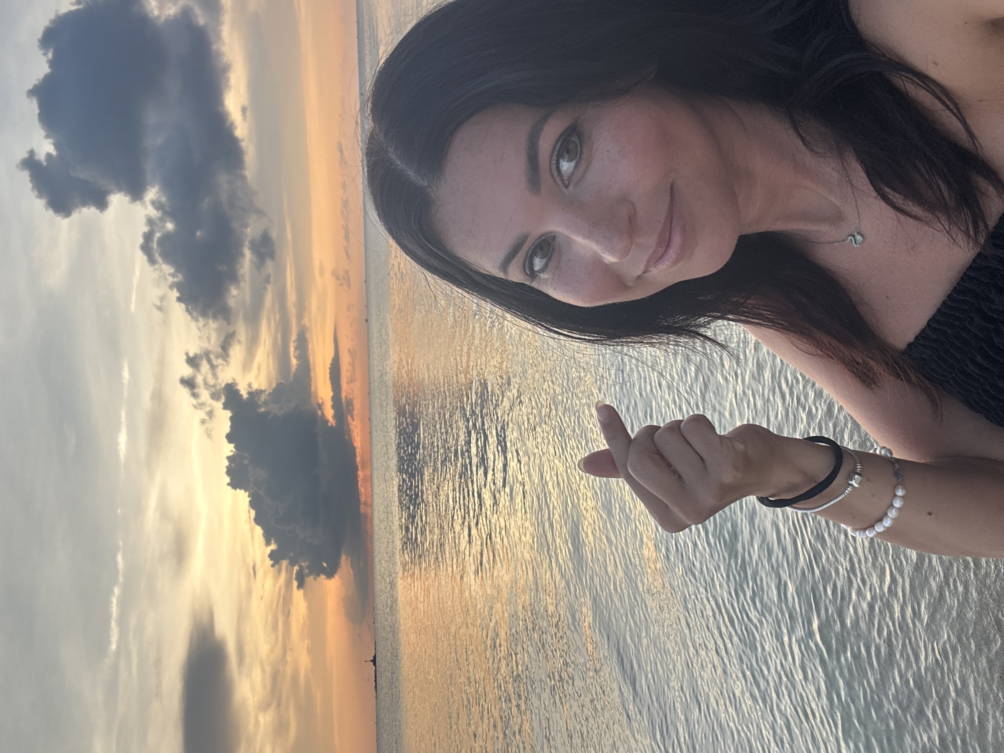 Woman takes sunset selfies on Thai beach