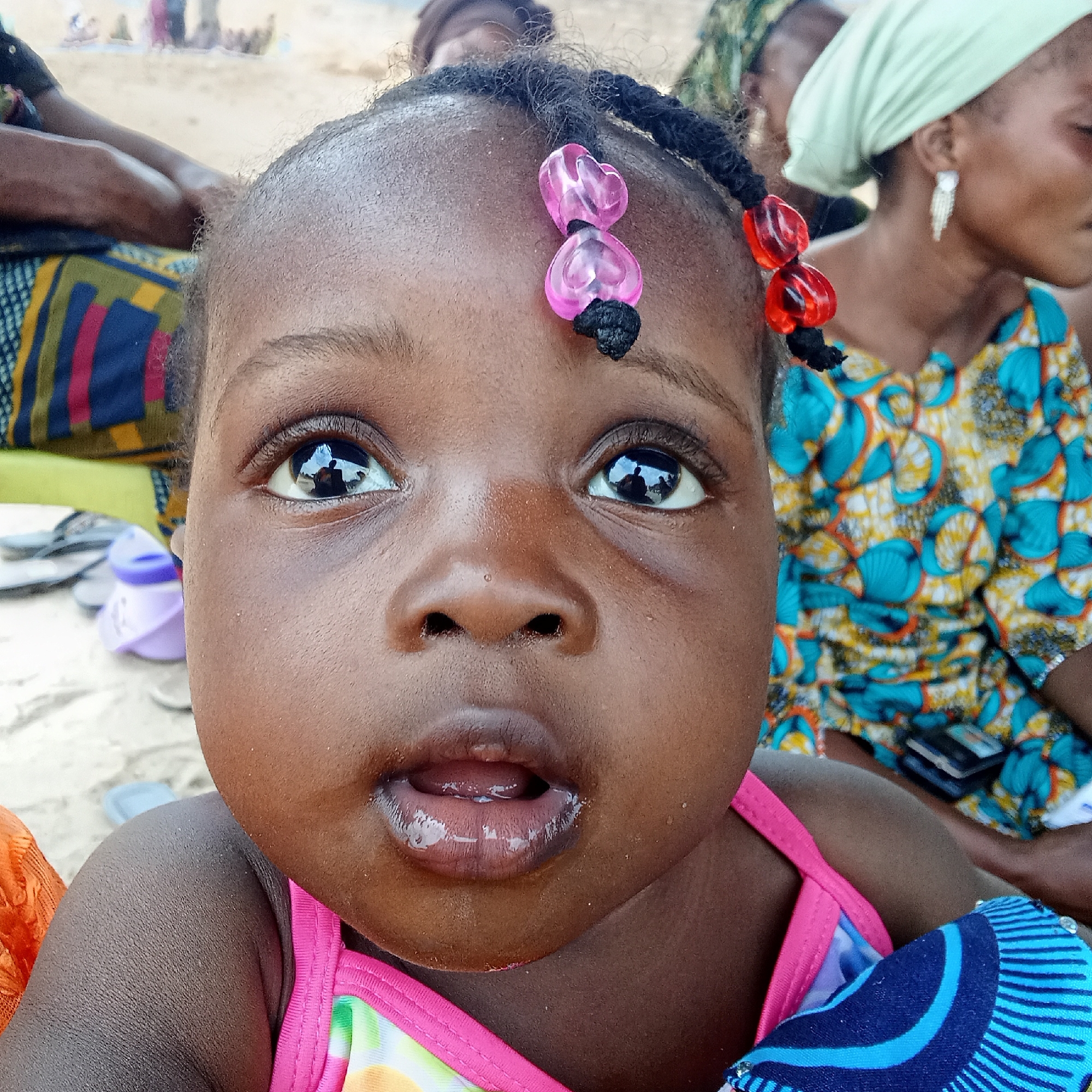 Women and children gather informally on mats in Doma, Nigeria