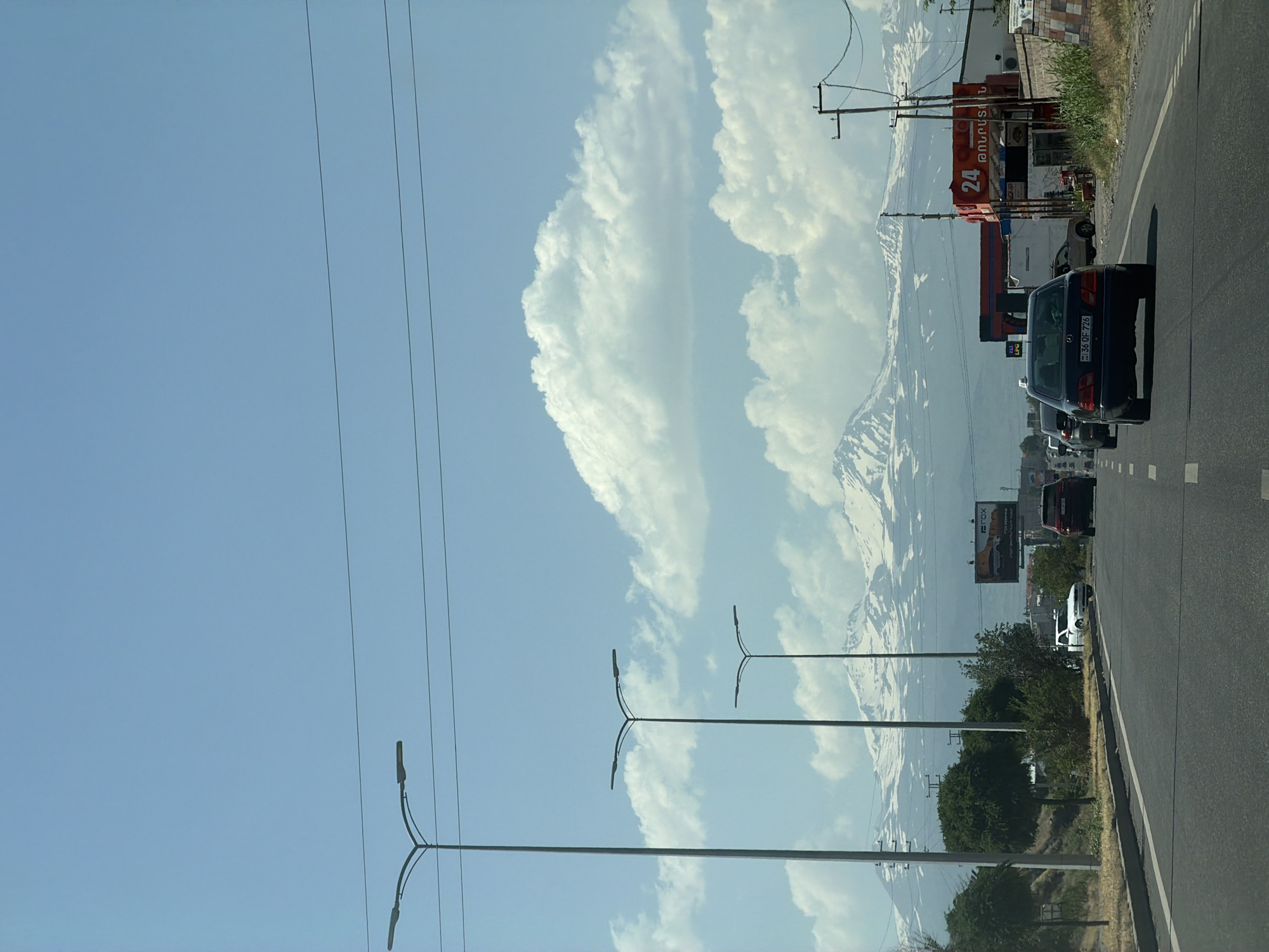 Road through Proshyan with snow-capped Armenian mountains behind
