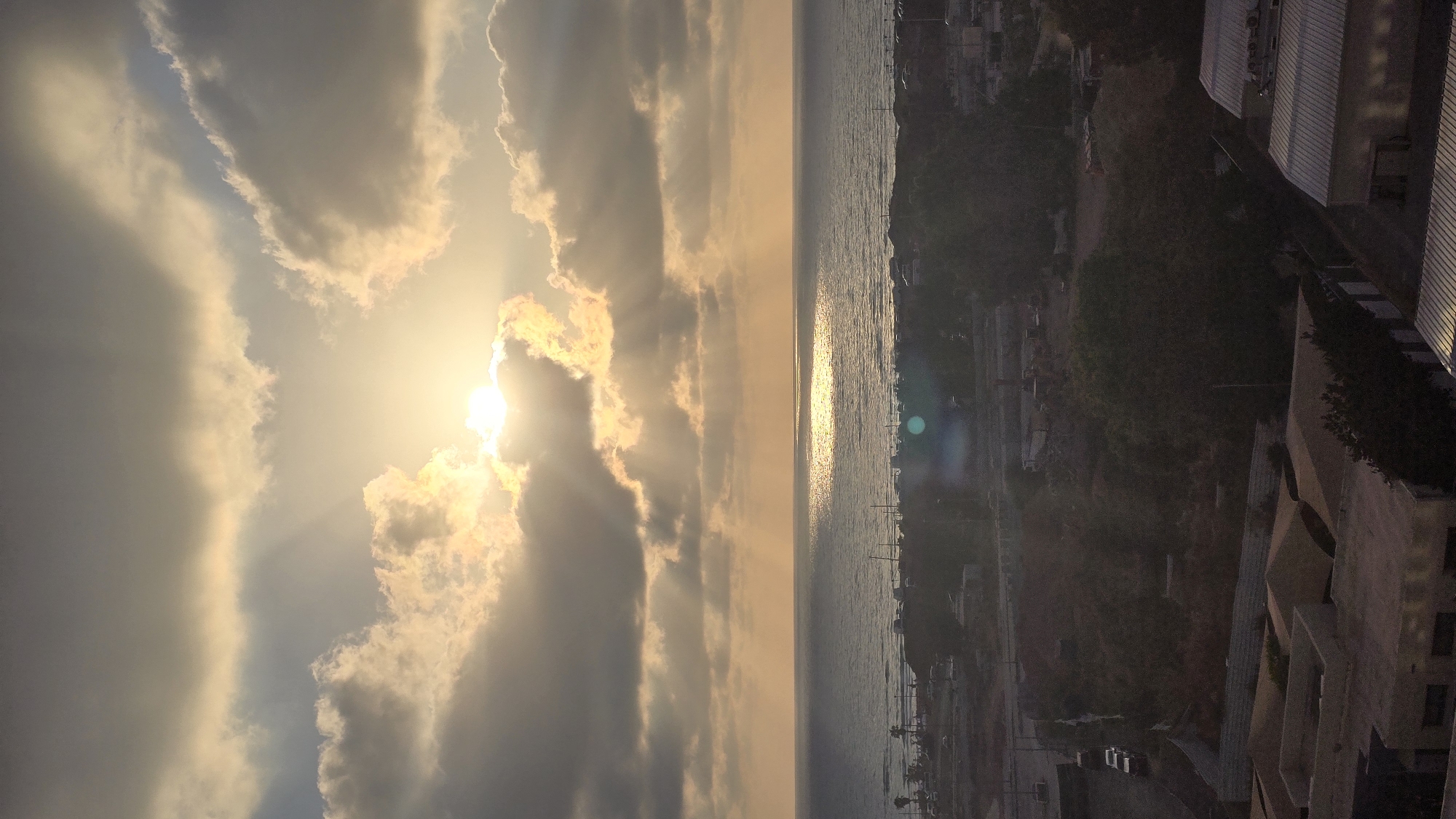 Sun breaking through clouds over Bat Yam's skyline
