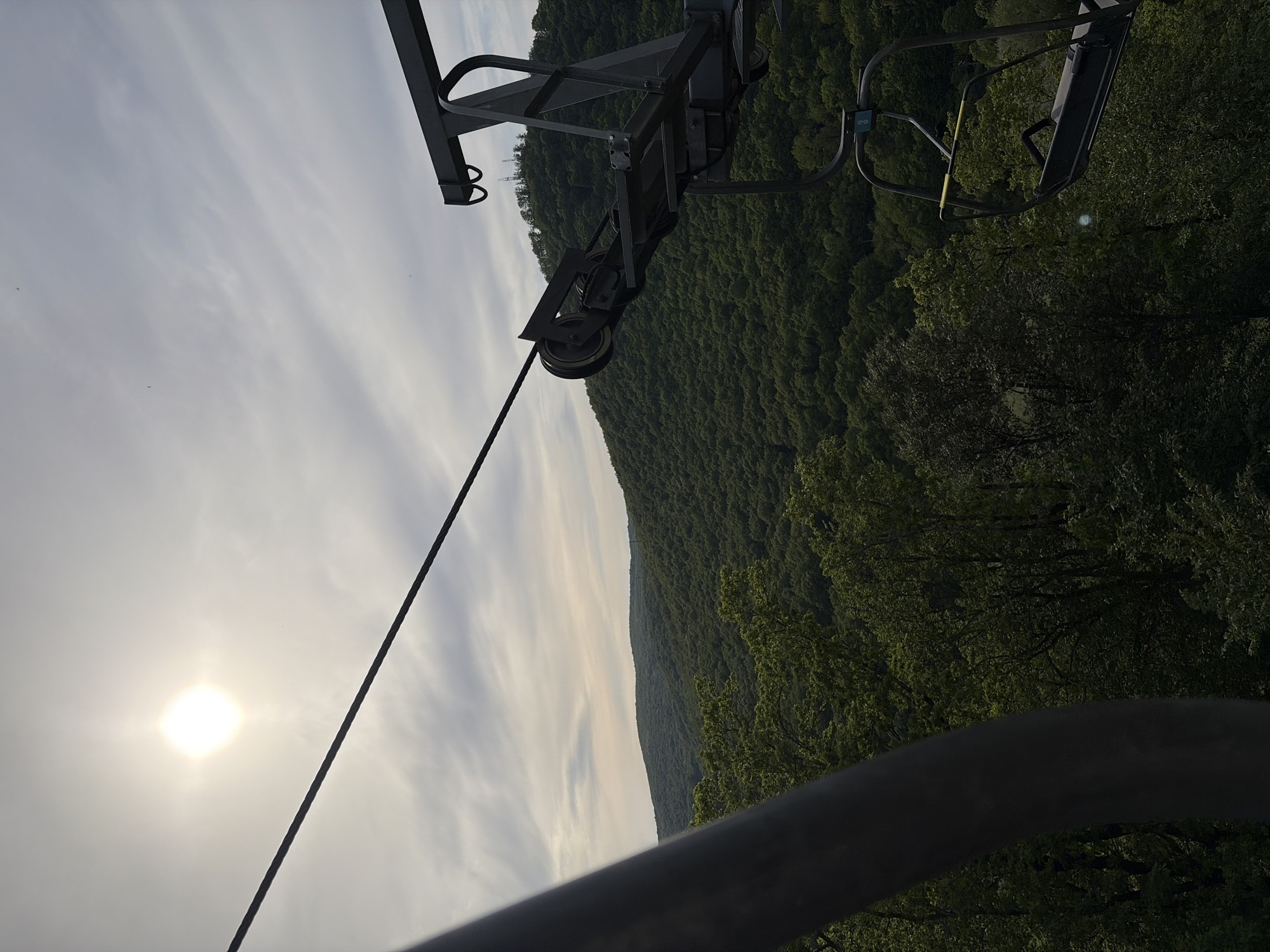 Chairlift operates over wooded mountains in Goryachiy Klyuch, Russia