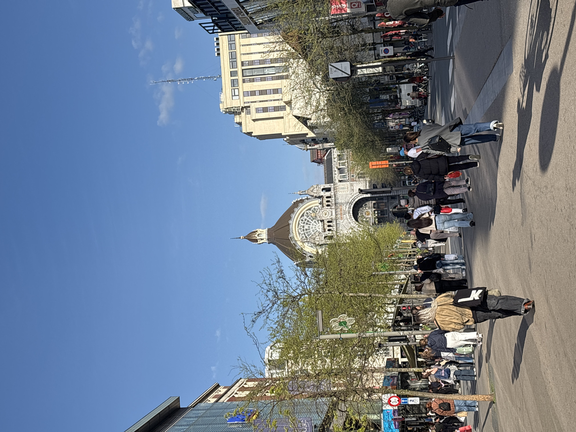 Pedestrians enjoy sunny afternoon on Antwerp boulevard