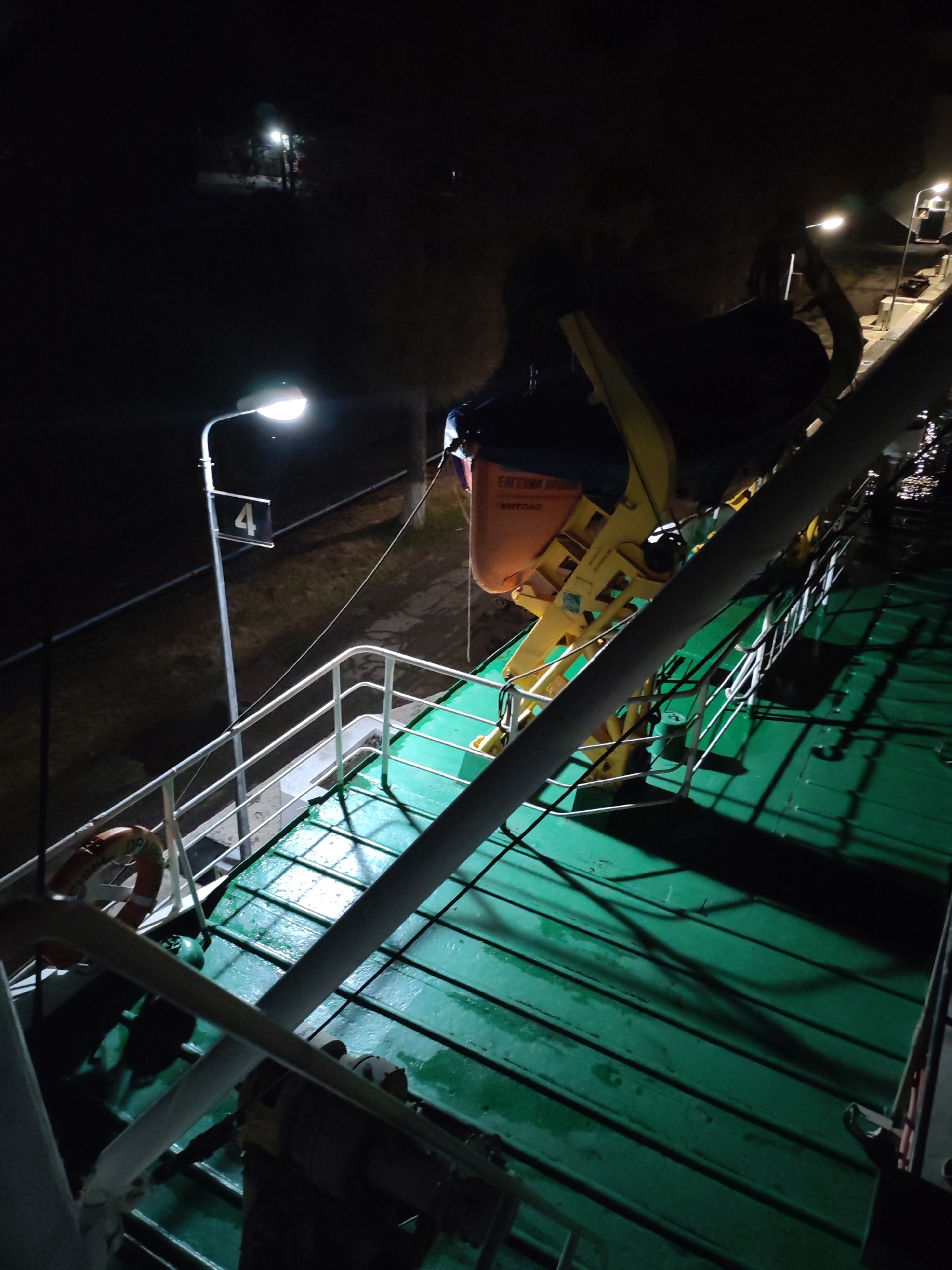 Vessel transits Russian river lock at night