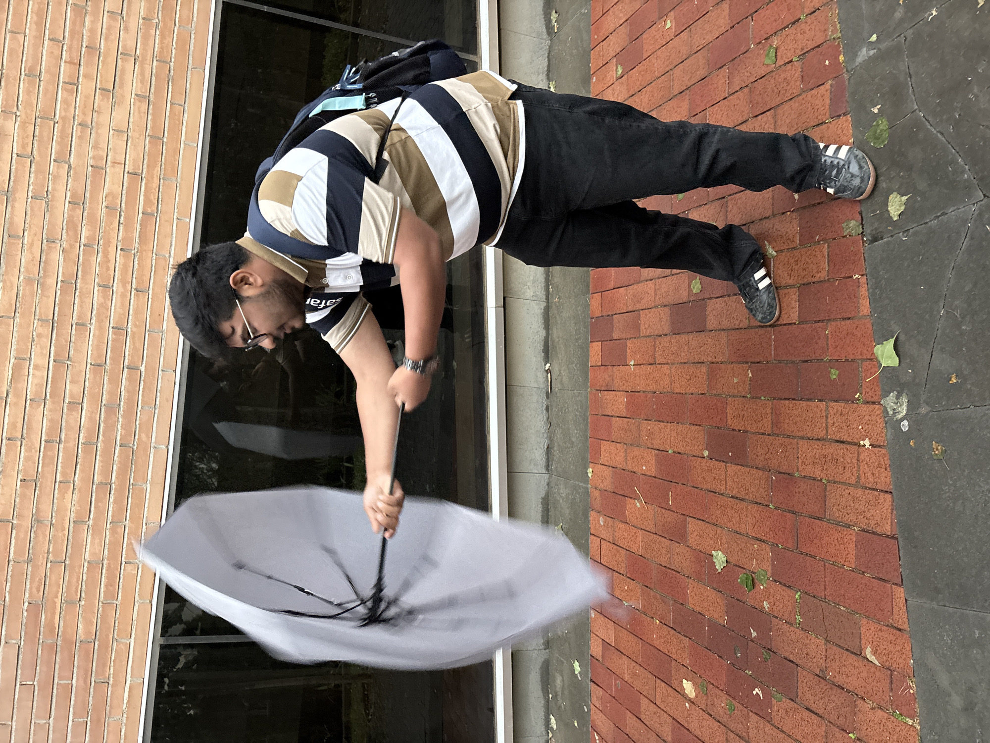 Barcelona residents weather windy rainstorm with umbrellas