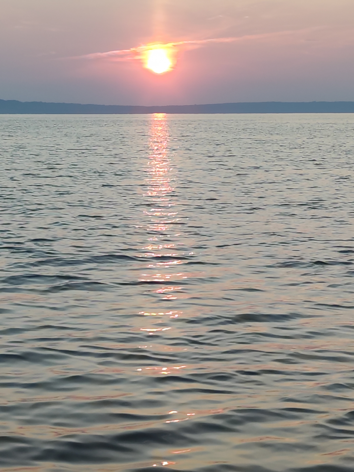 Kama River sunset glows orange over Chaikovsky, Russia