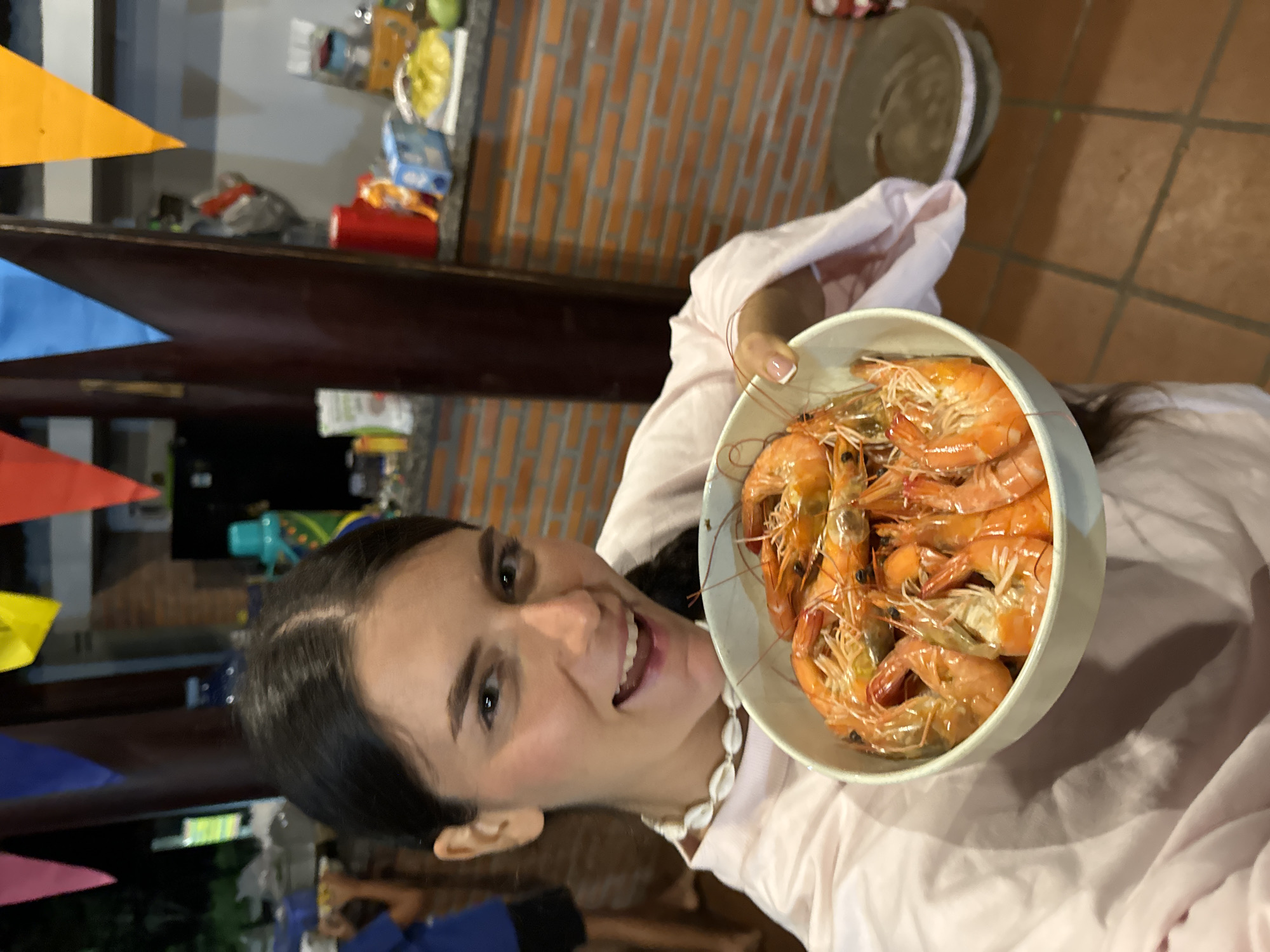Woman displays bowl of fresh shrimp in Mũi Né