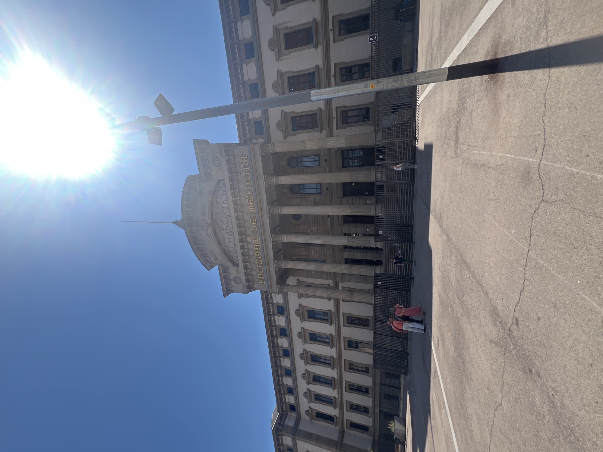 Barcelona's Faculty of Medicine building on a clear July afternoon