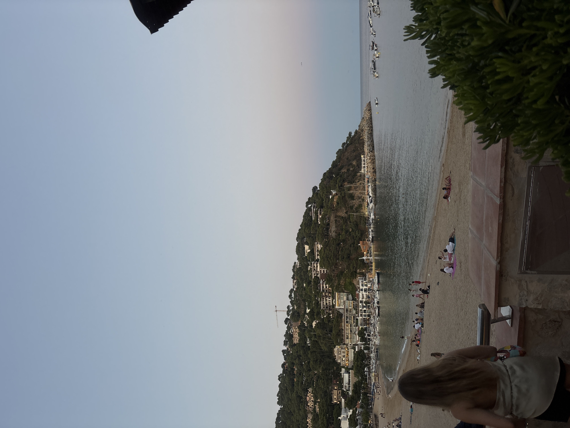 Dusk settles over Llafranc's sandy beach