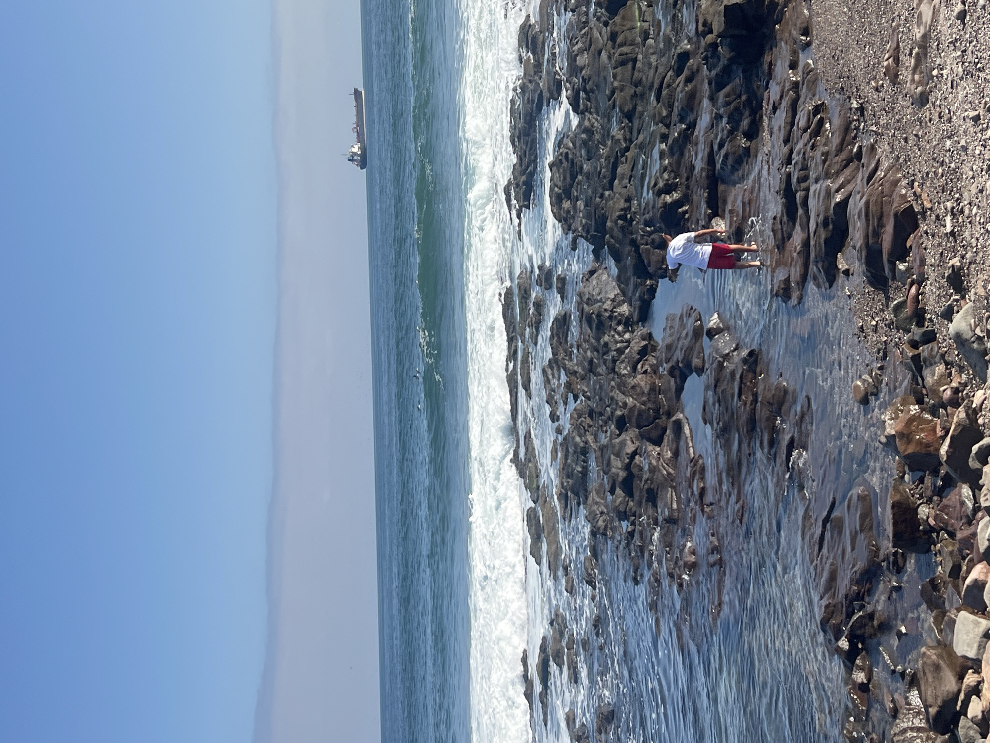 Rocky coastline documented in Arica, Chile during evening hours