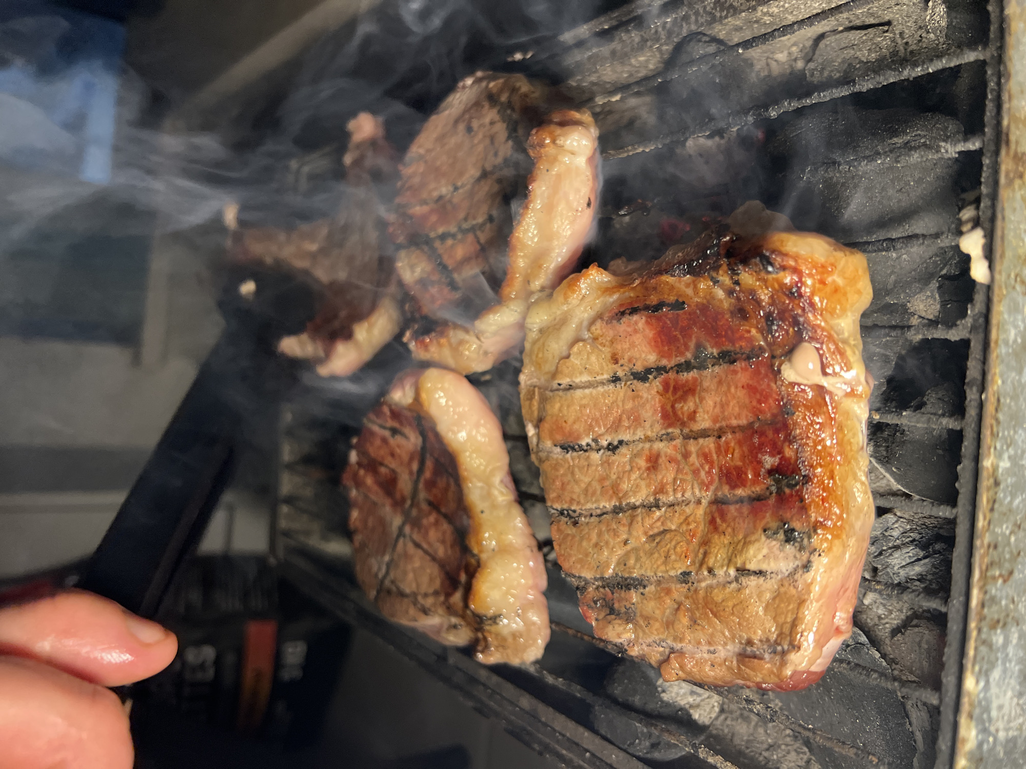 Steaks grilling on charcoal barbecue in Kiryat Bialik