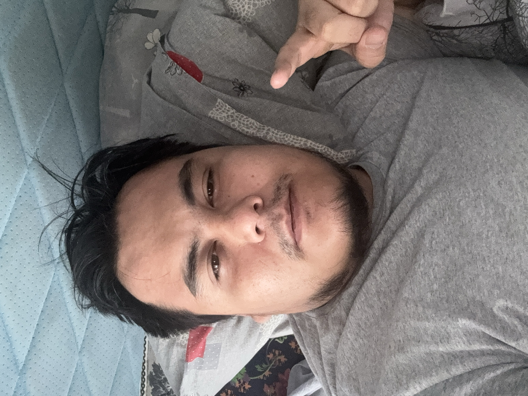 Casual indoor selfie from a bed in Chirchik, Uzbekistan