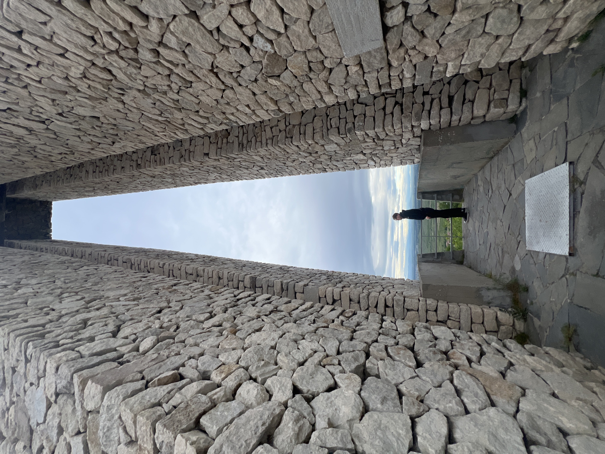 Tourist documents historic stone monuments in Perushtitsa, Bulgaria
