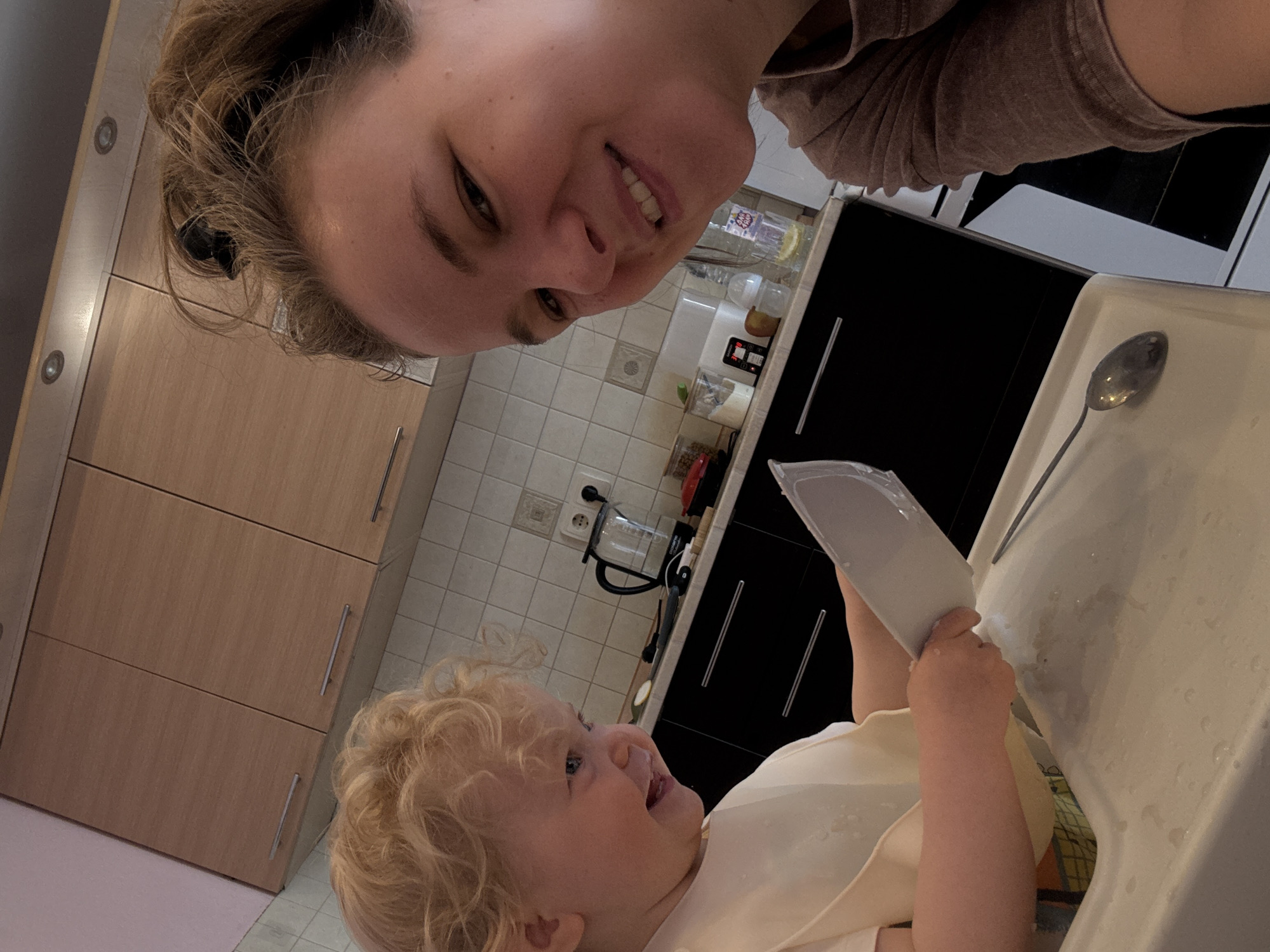 Morning mealtime captured between mother and toddler in kitchen