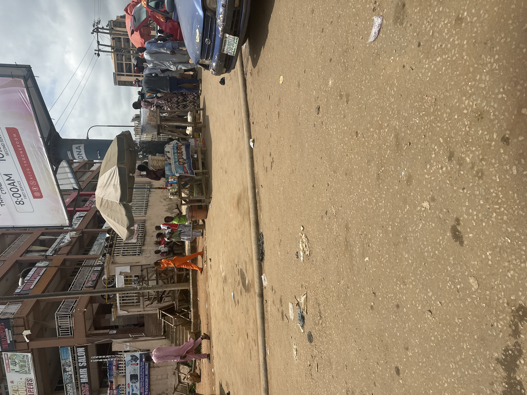 Keke NAPEPs and street traffic at an Abuja intersection