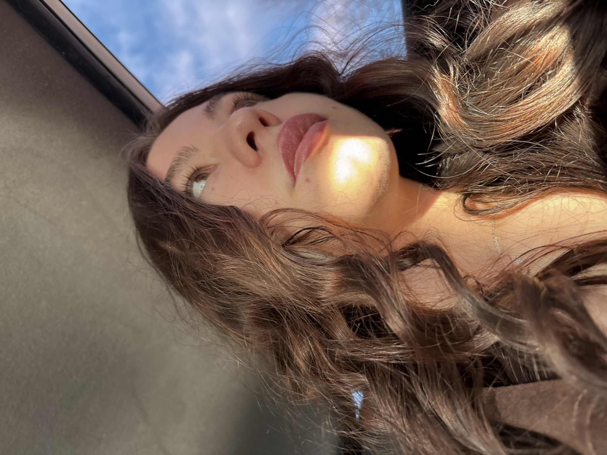 Woman photographed in natural sunlight portrait in Perm, Russia