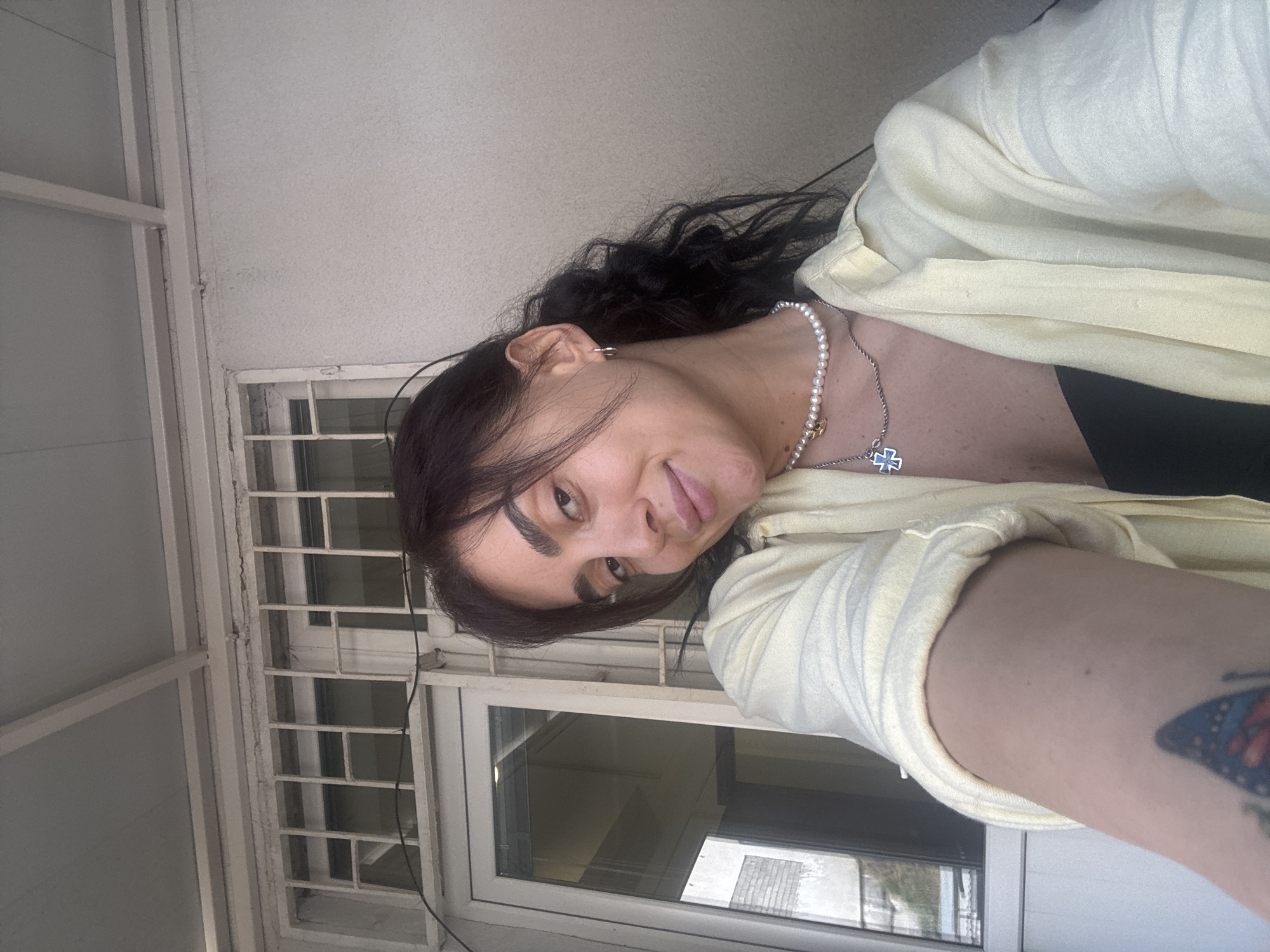 Casual photo moment against a Tbilisi wall, August 2026