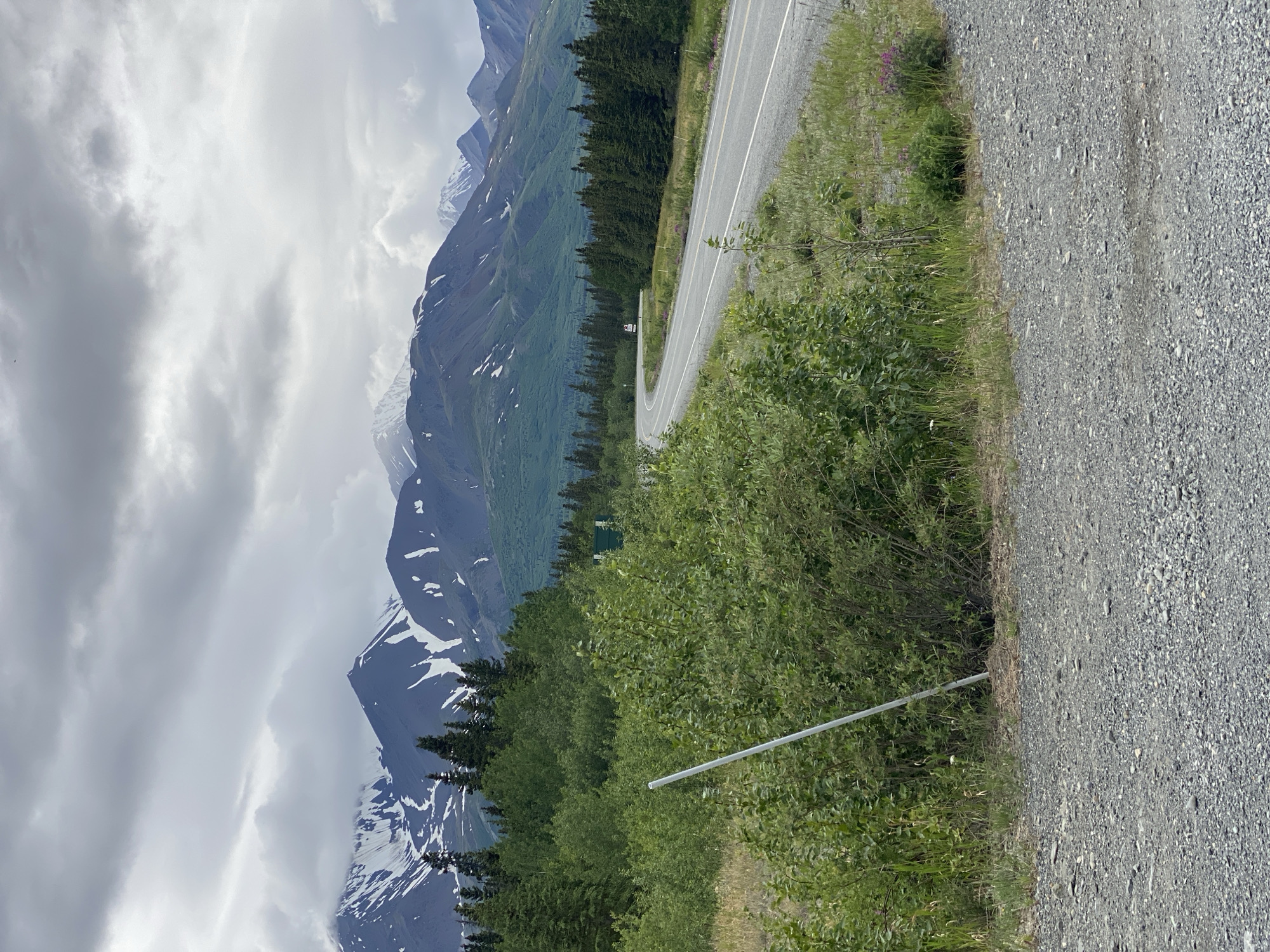 Roads, mountains, and a log cabin in remote Bear Creek, Canada