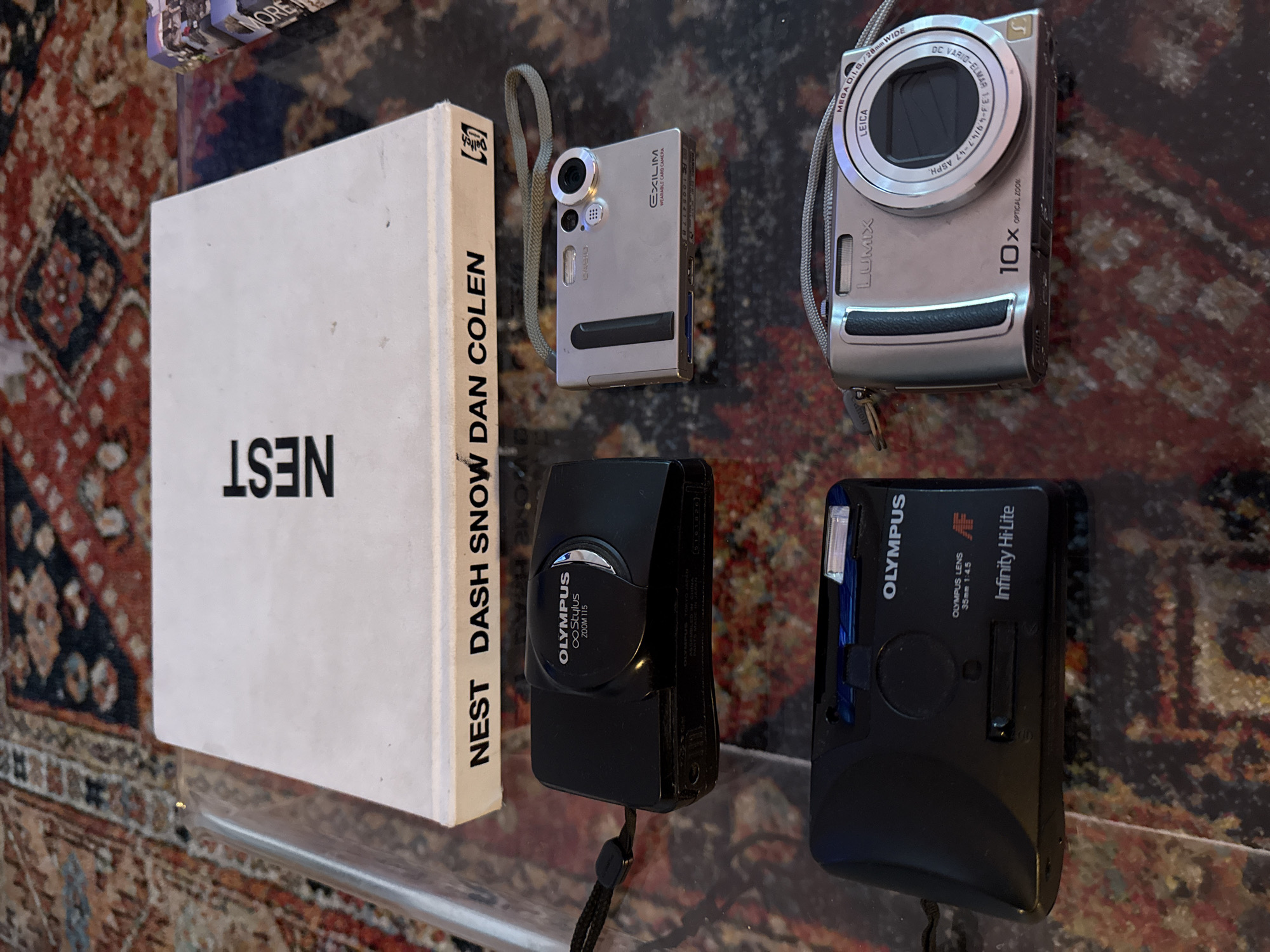Cameras and book displayed on glass table in New York