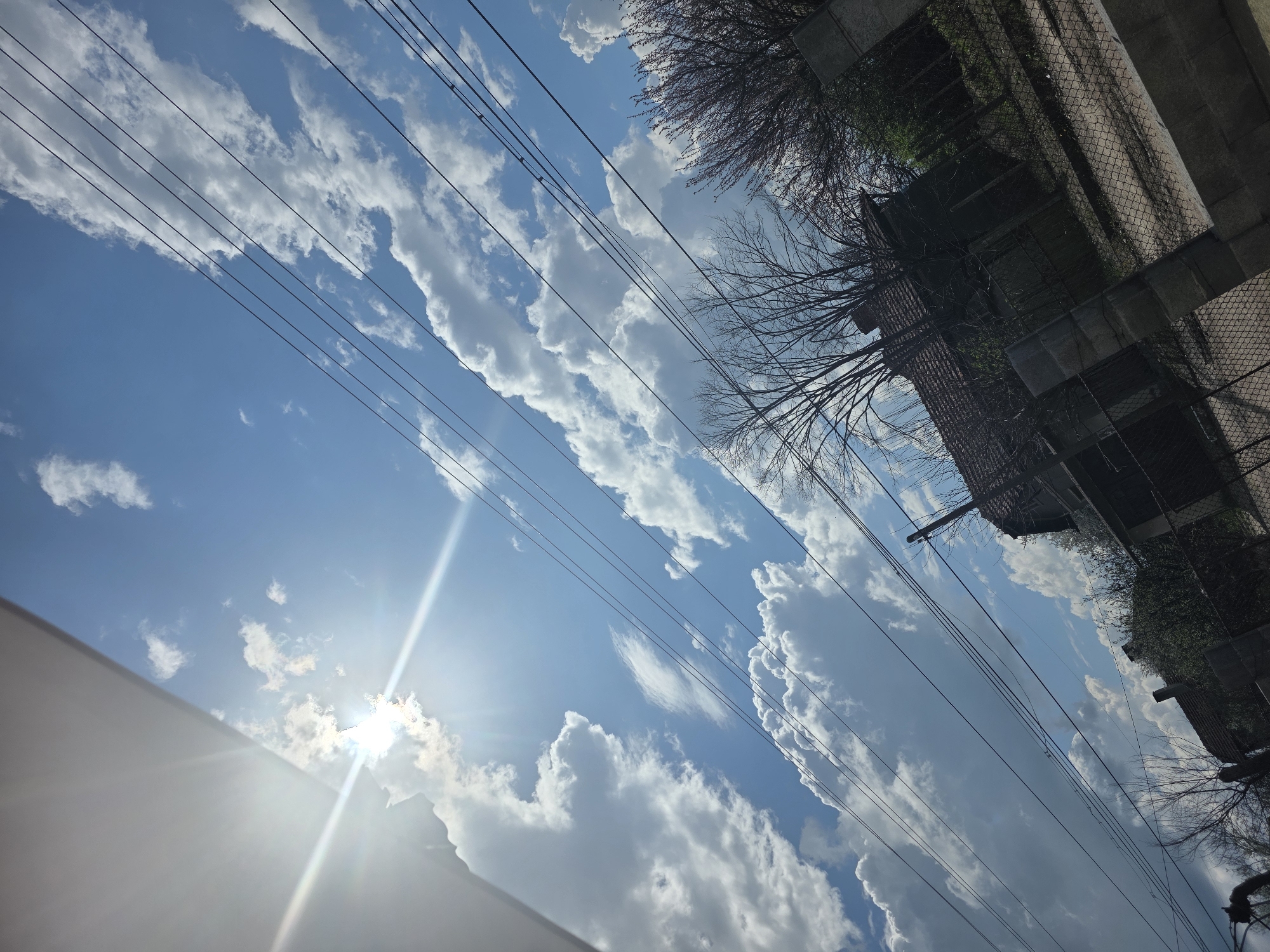 Sky view with clouds and power lines observed in Lom