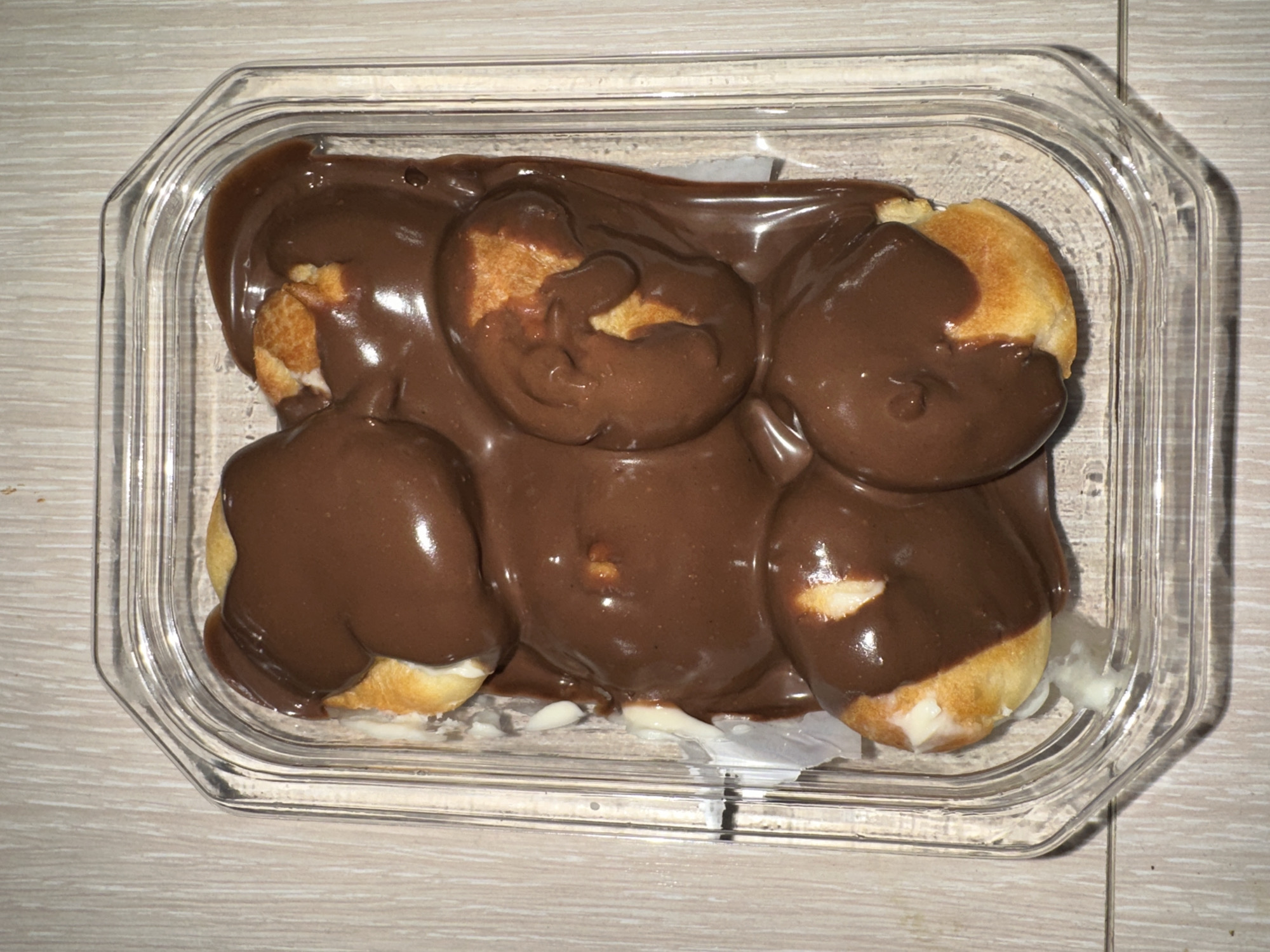 Chocolate-covered cream puffs observed in container in Khimki