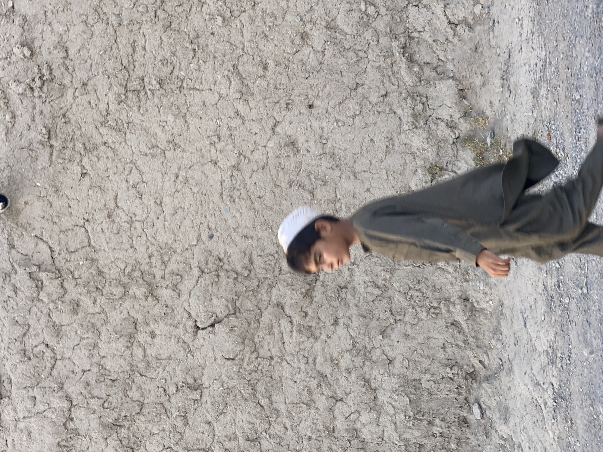 Everyday street life along a dusty Kandahar road