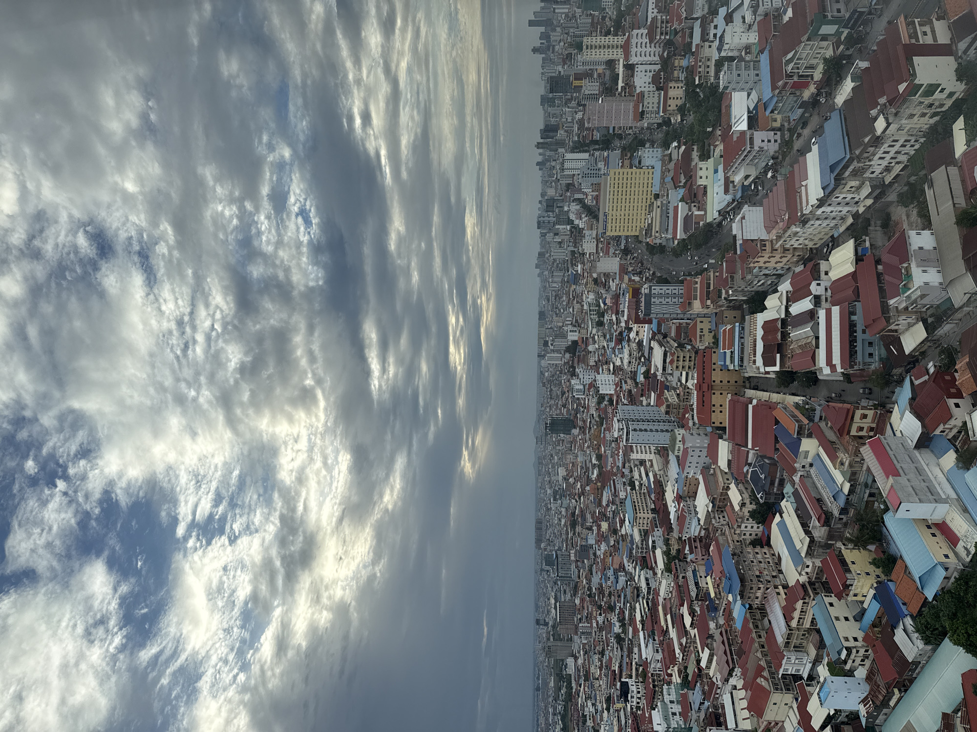 Aerial views over dense Khan Mean Chey rooftops under stormy skies