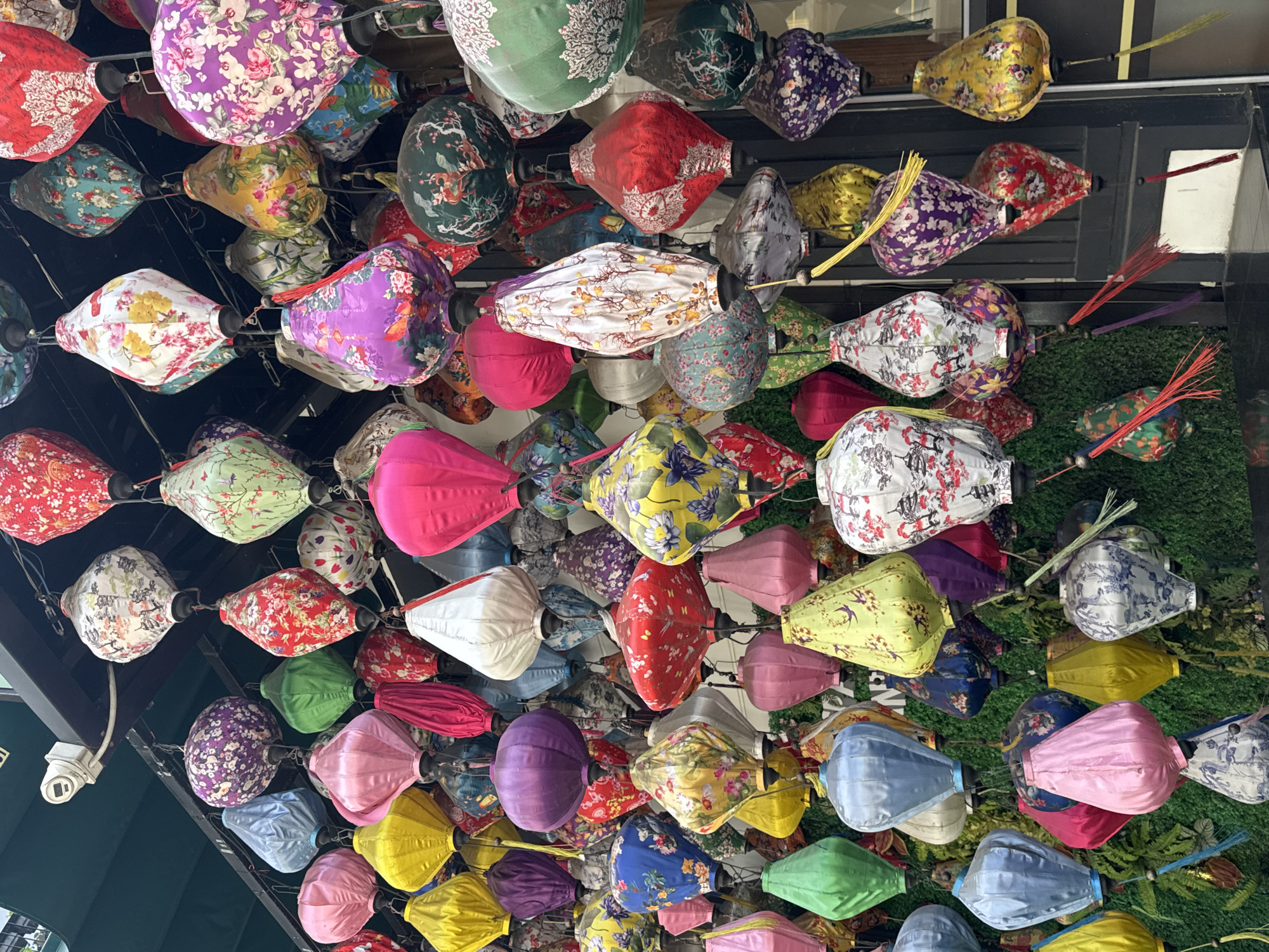 Tourist poses beneath colorful lantern display in Đà Nẵng