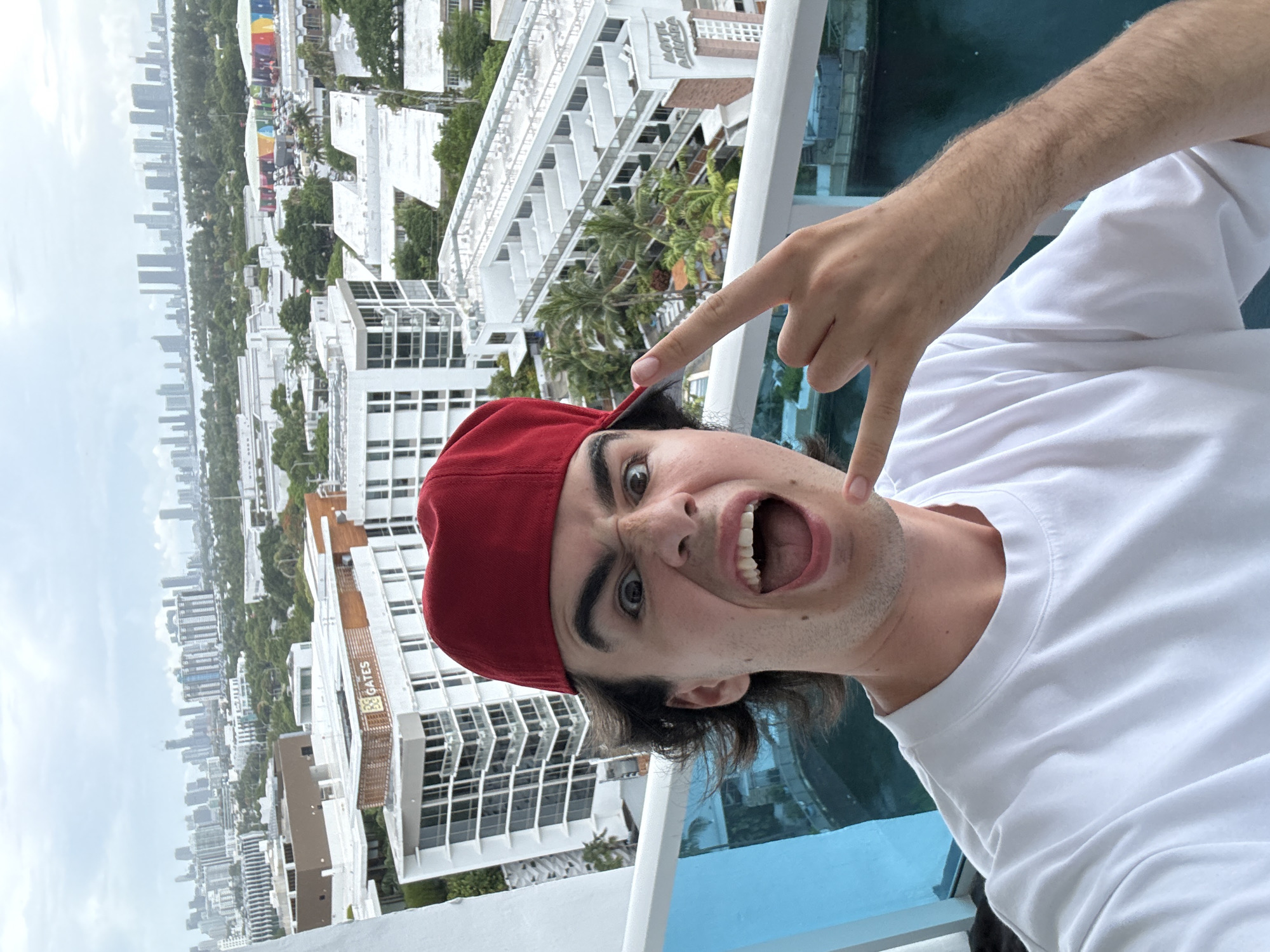Man Takes Selfies on Miami Beach Balcony with Supreme Case