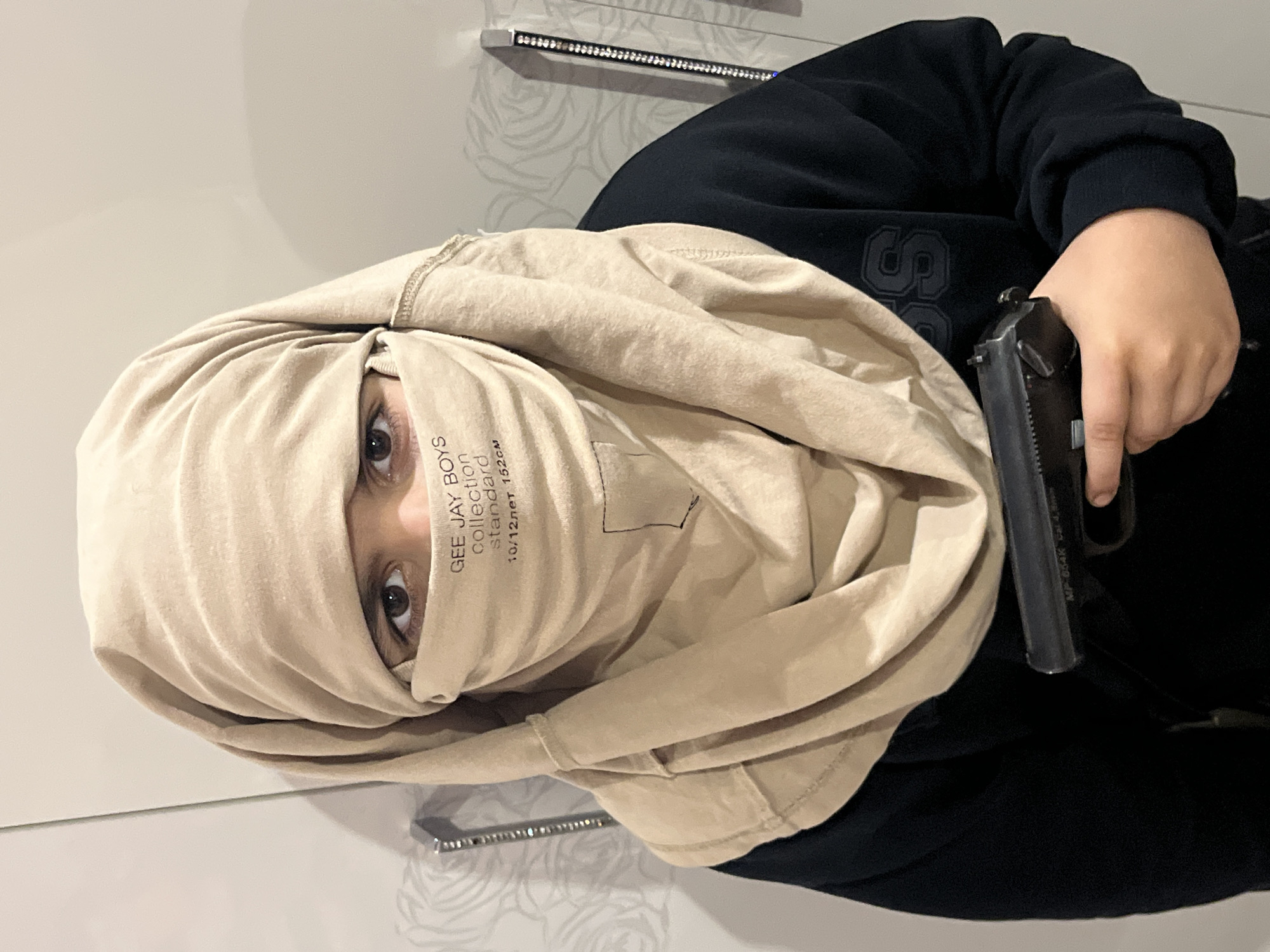 Posed indoor photos with toy guns and face coverings, Kostroma