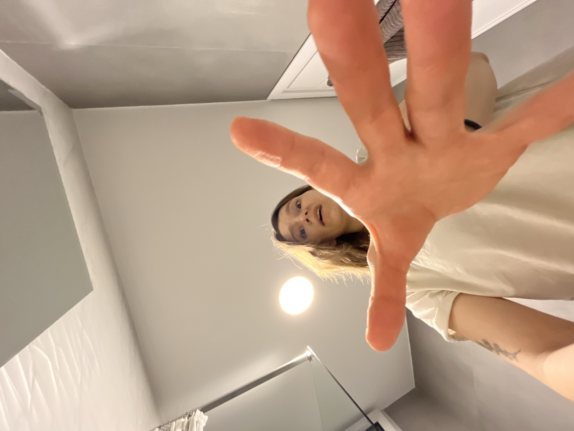 Woman reaches toward camera in indoor Limassol setting