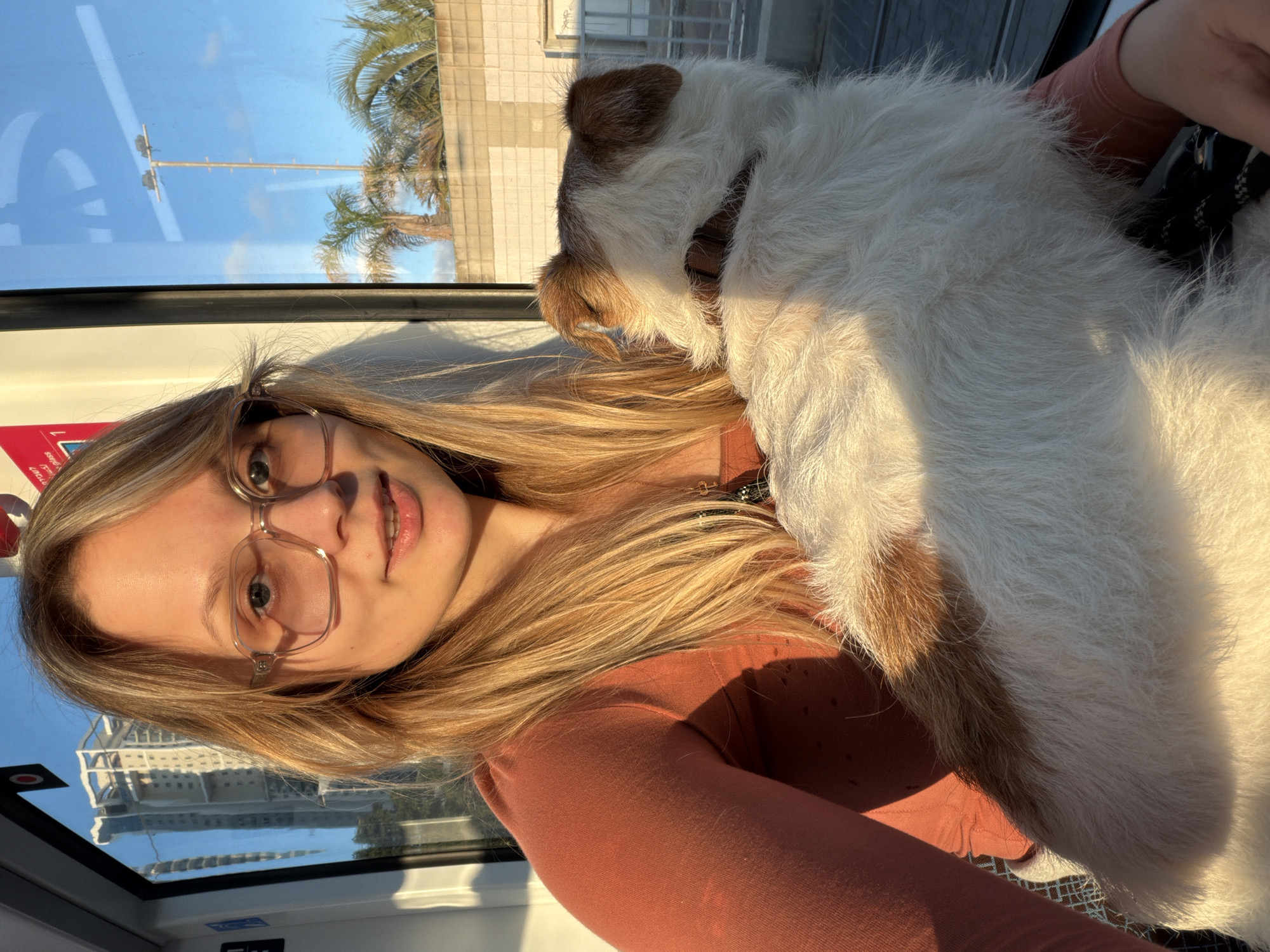 Woman travels with small dog on public transit in Bat Yam