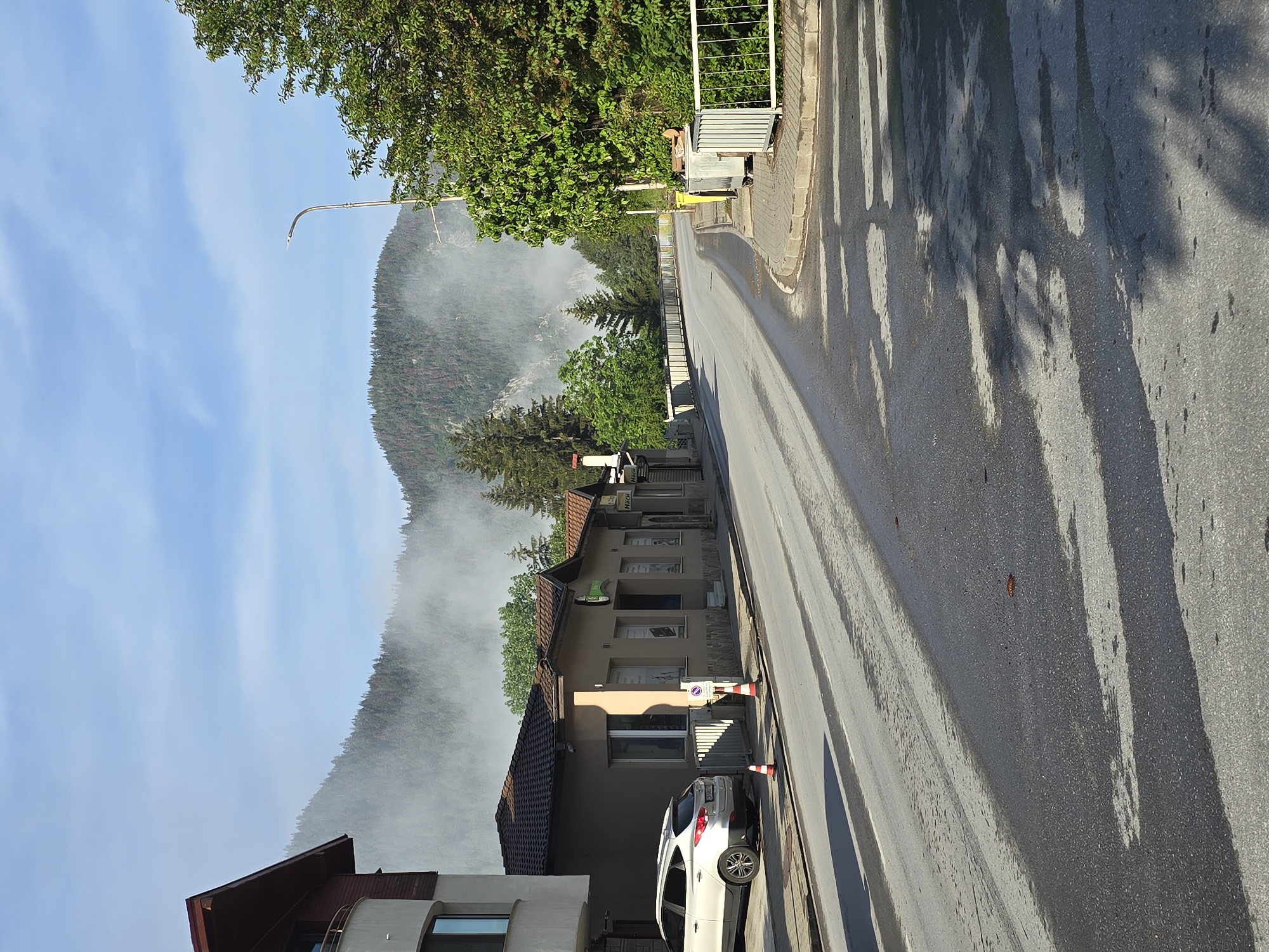 Misty dawn street scene captured in forested hills