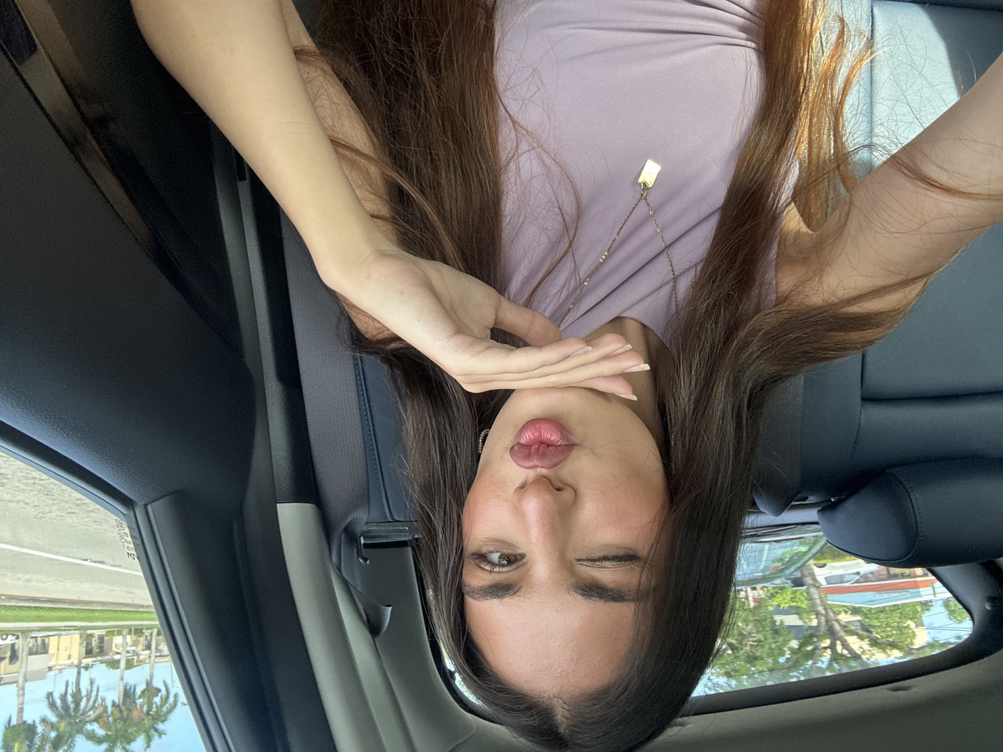 Woman in purple top observed in vehicle backseat, Boca Raton