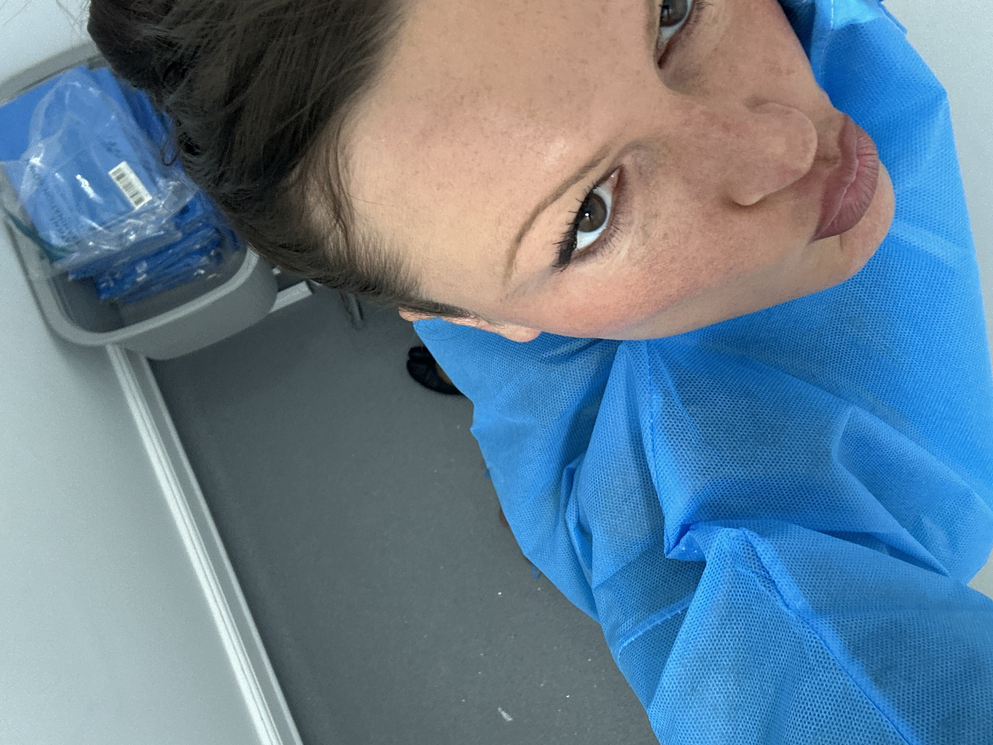 Woman in blue medical gown observed in London