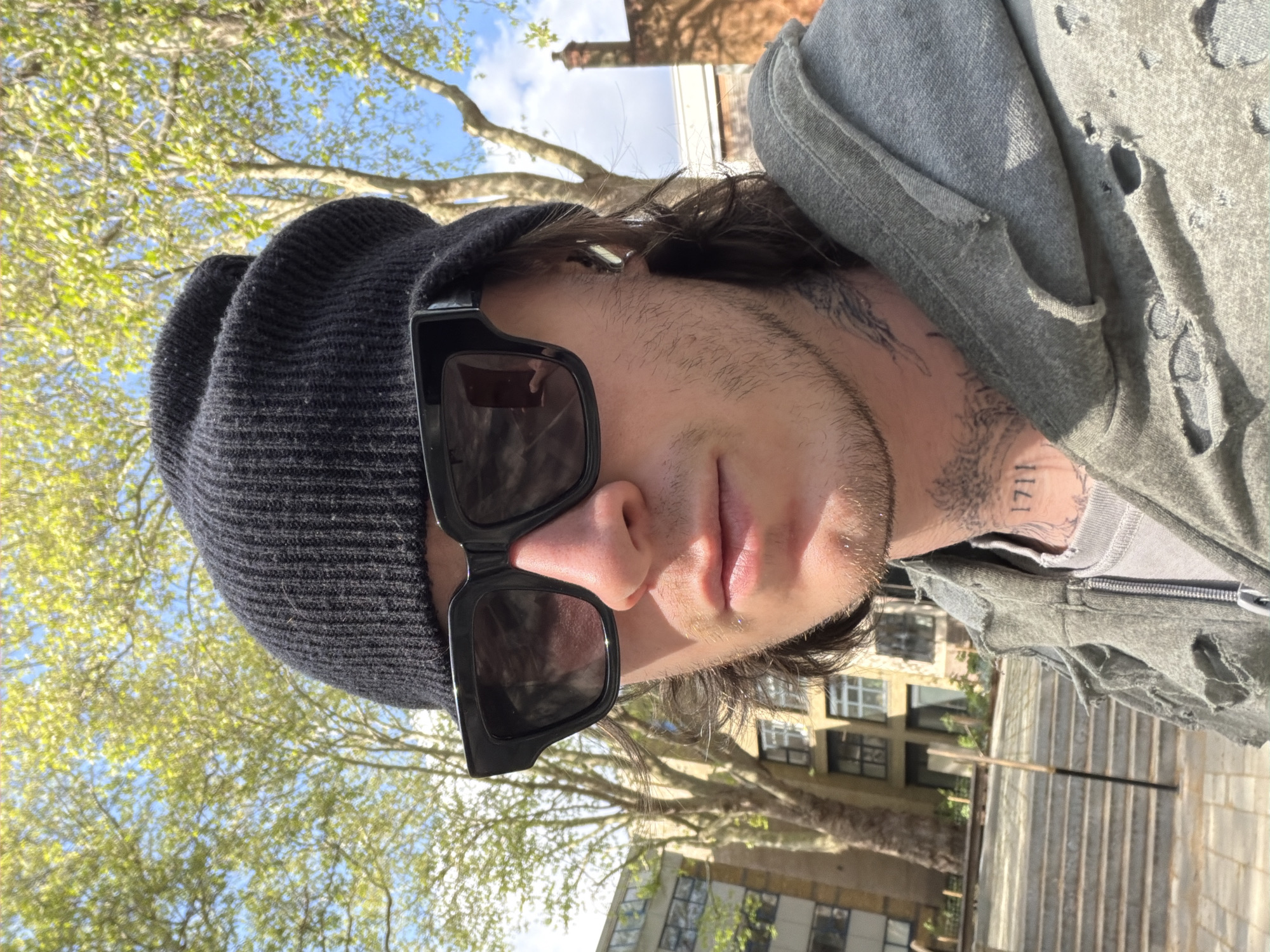 Young adult photographed outdoors in London on sunny afternoon