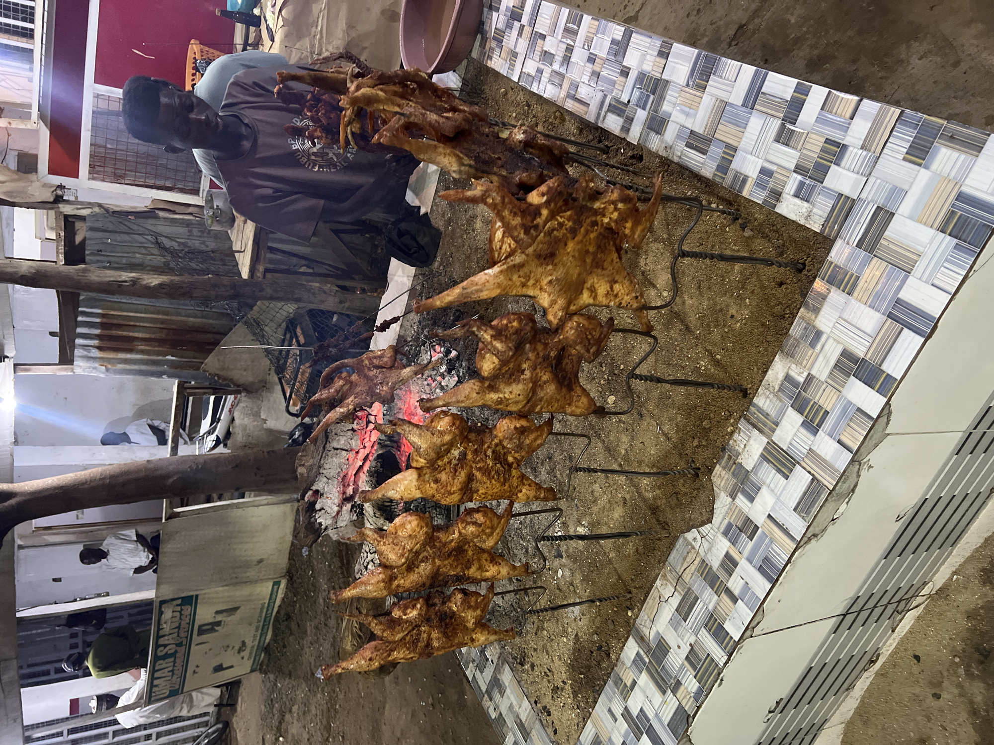 Rotisserie chicken stall firing up for the night in Bauchi