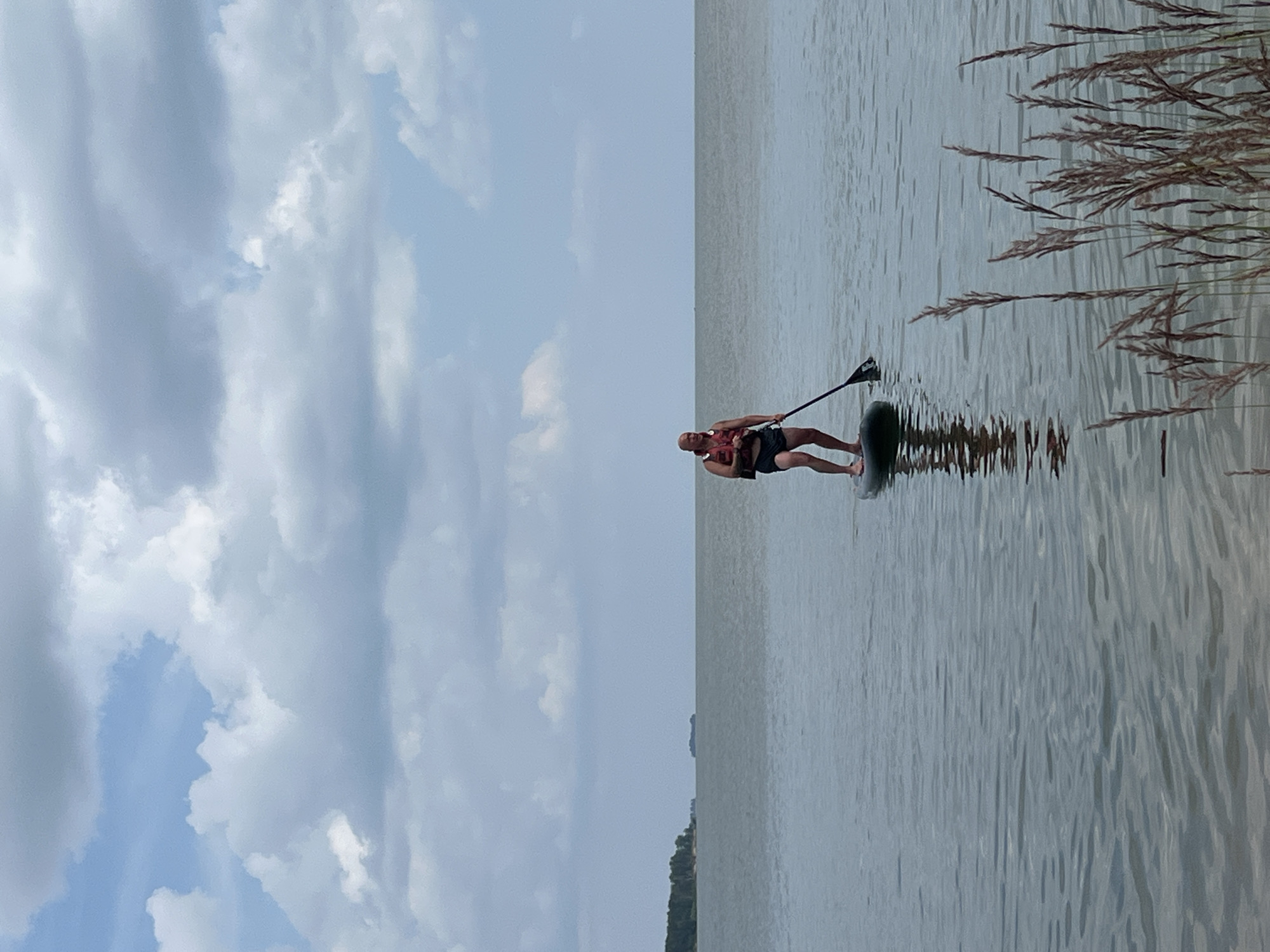 Paddleboarding on a calm Borovoe lake on a cloudy morning