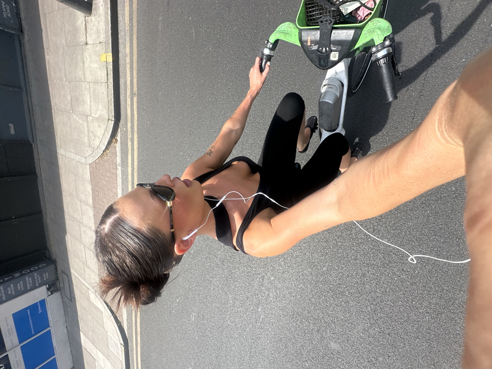 Person rides Lime electric bike through London streets