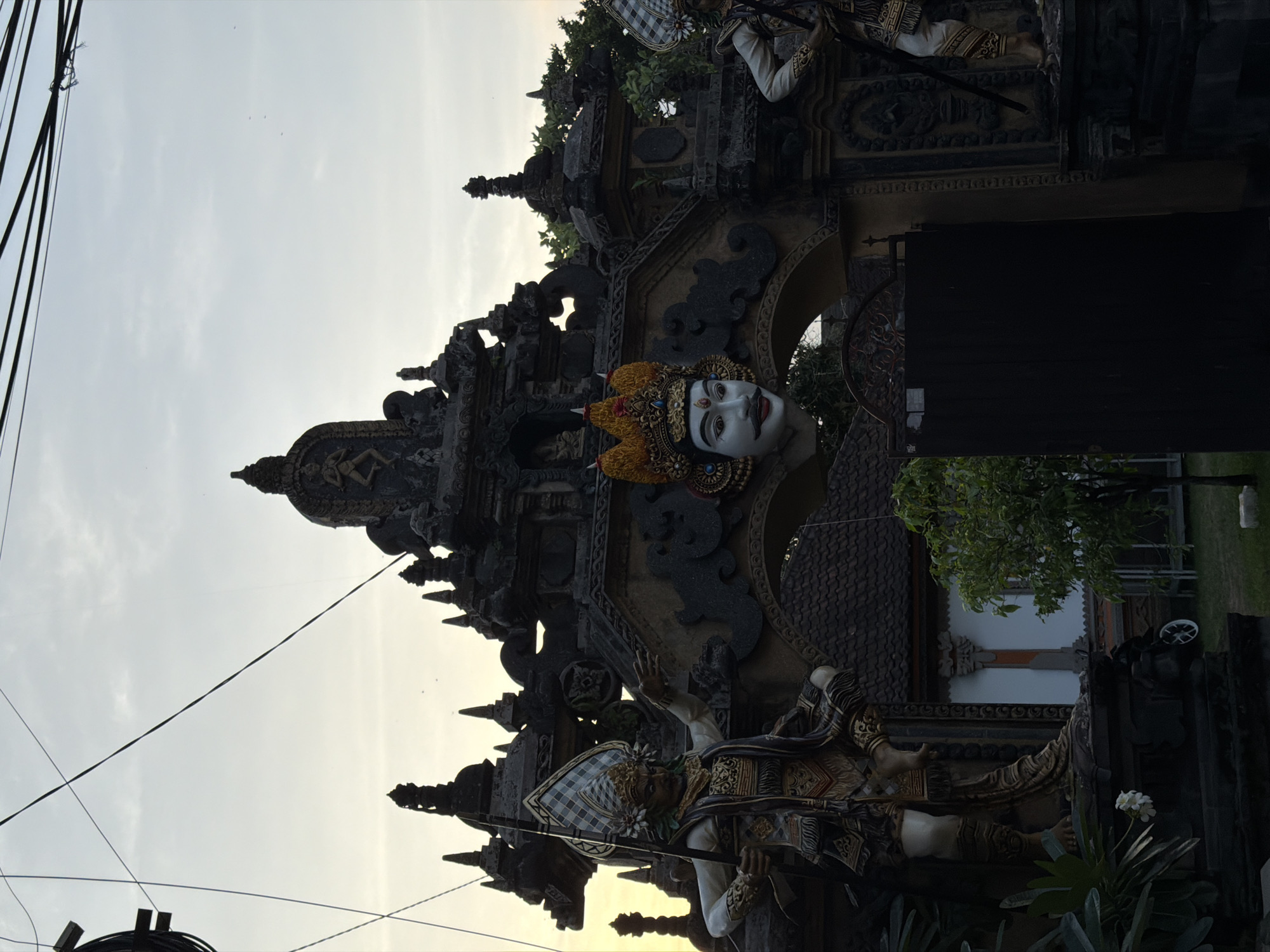 Tourist documents Balinese property with flowers, pool, traditional architecture